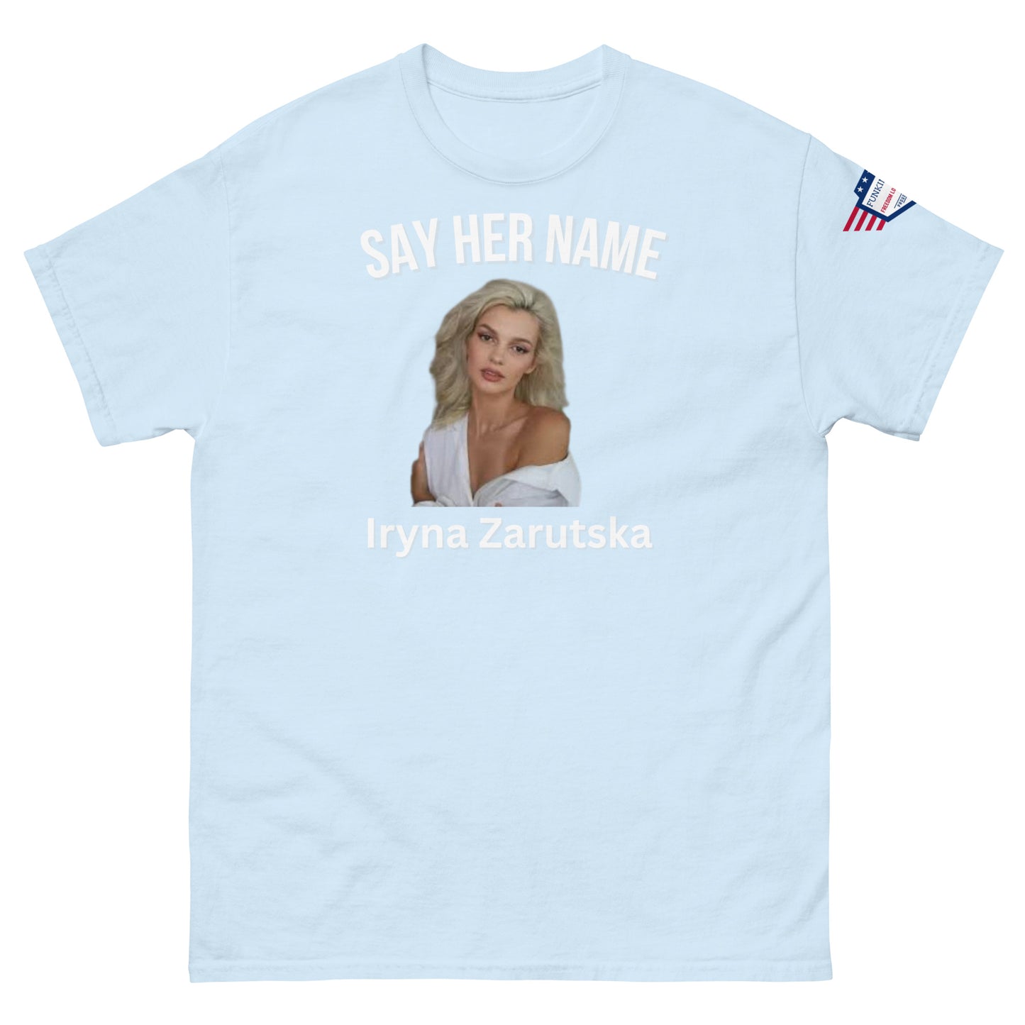 Front view of baby blue unisex tee with "SAY HER NAME" arch, Iryna Zarzutska blonde portrait, name text below, US flag sleeve patch
