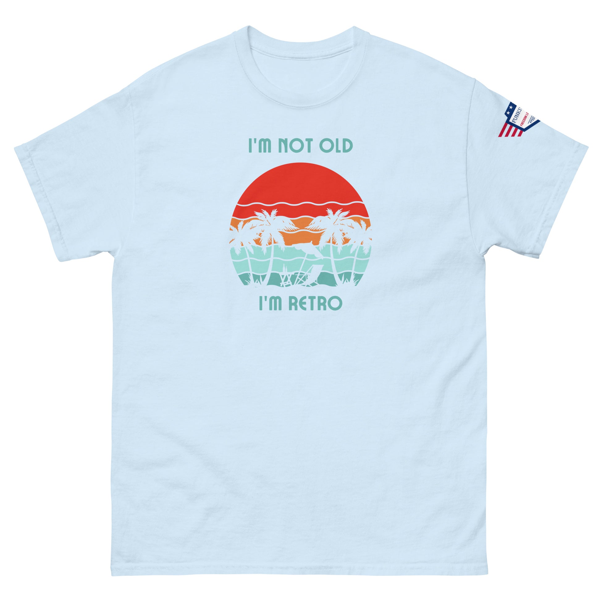 Front view of light blue "I'm Not Old I'm Retro" unisex tee with red sunset palms graphic and USA sleeve patch