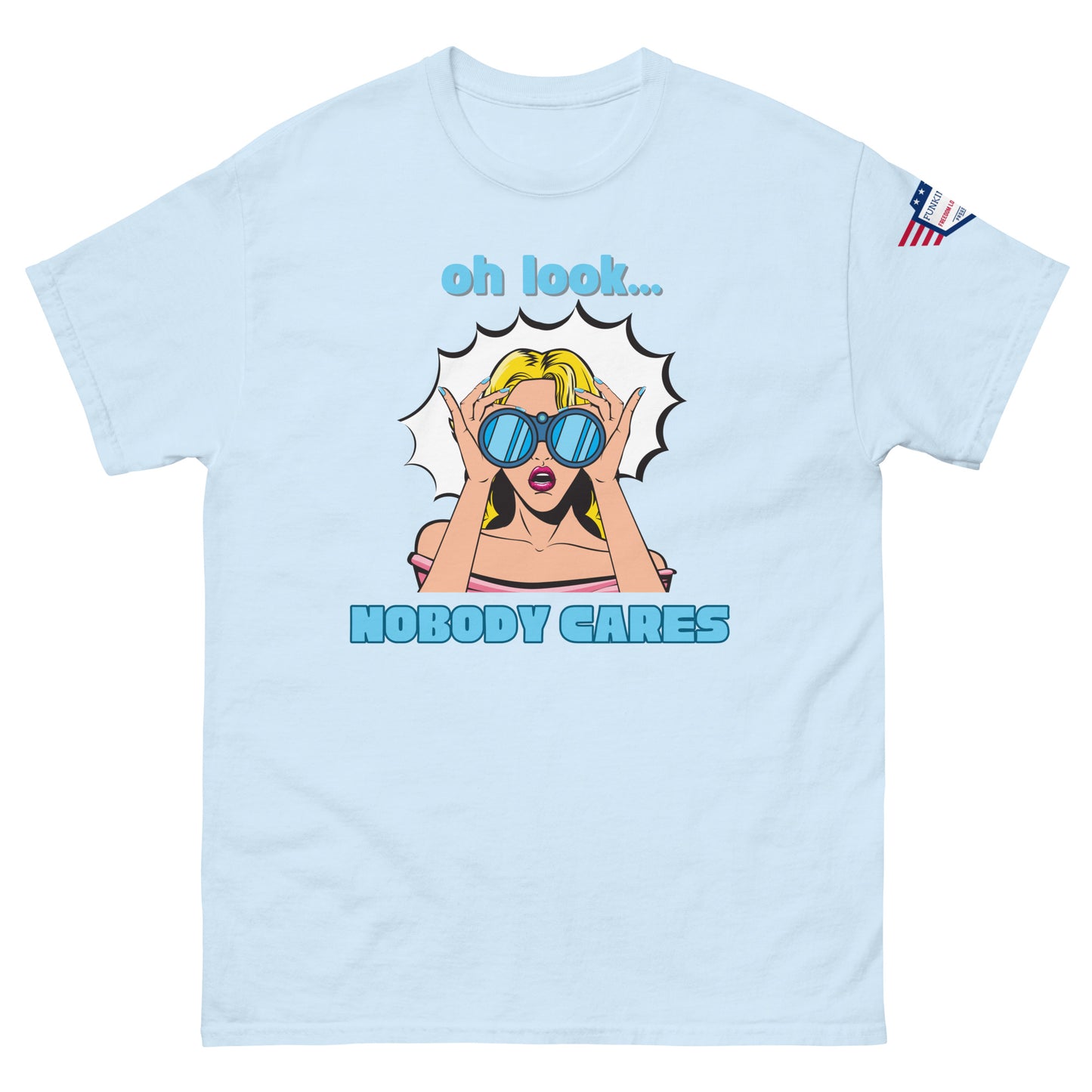 Front view of light blue unisex t-shirt with "oh look... NOBODY CARES" pop-art blonde in shades, USA flag sleeve patch