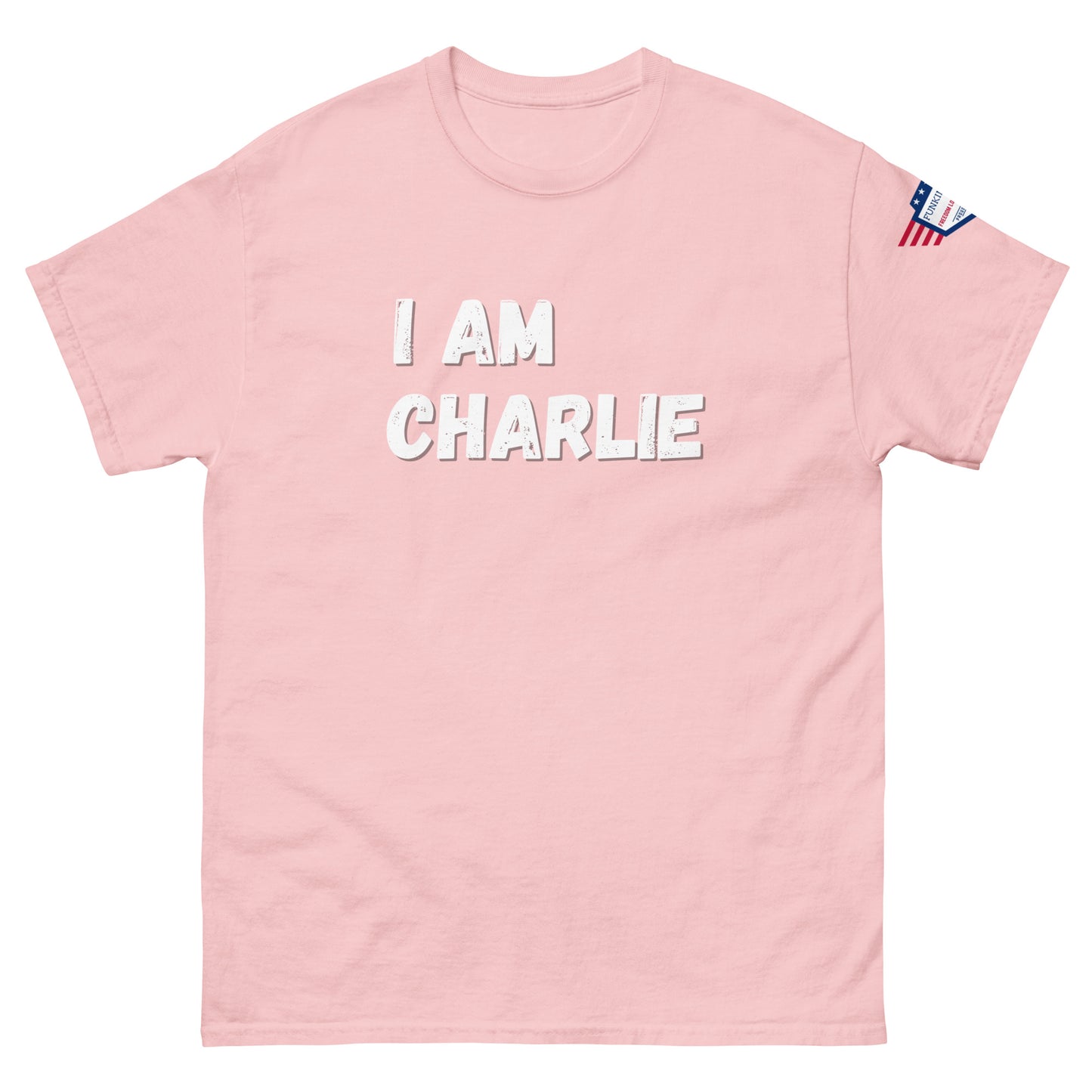 Baby pink unisex tee front, white "I AM CHARLIE" print pops, US flag on right sleeve