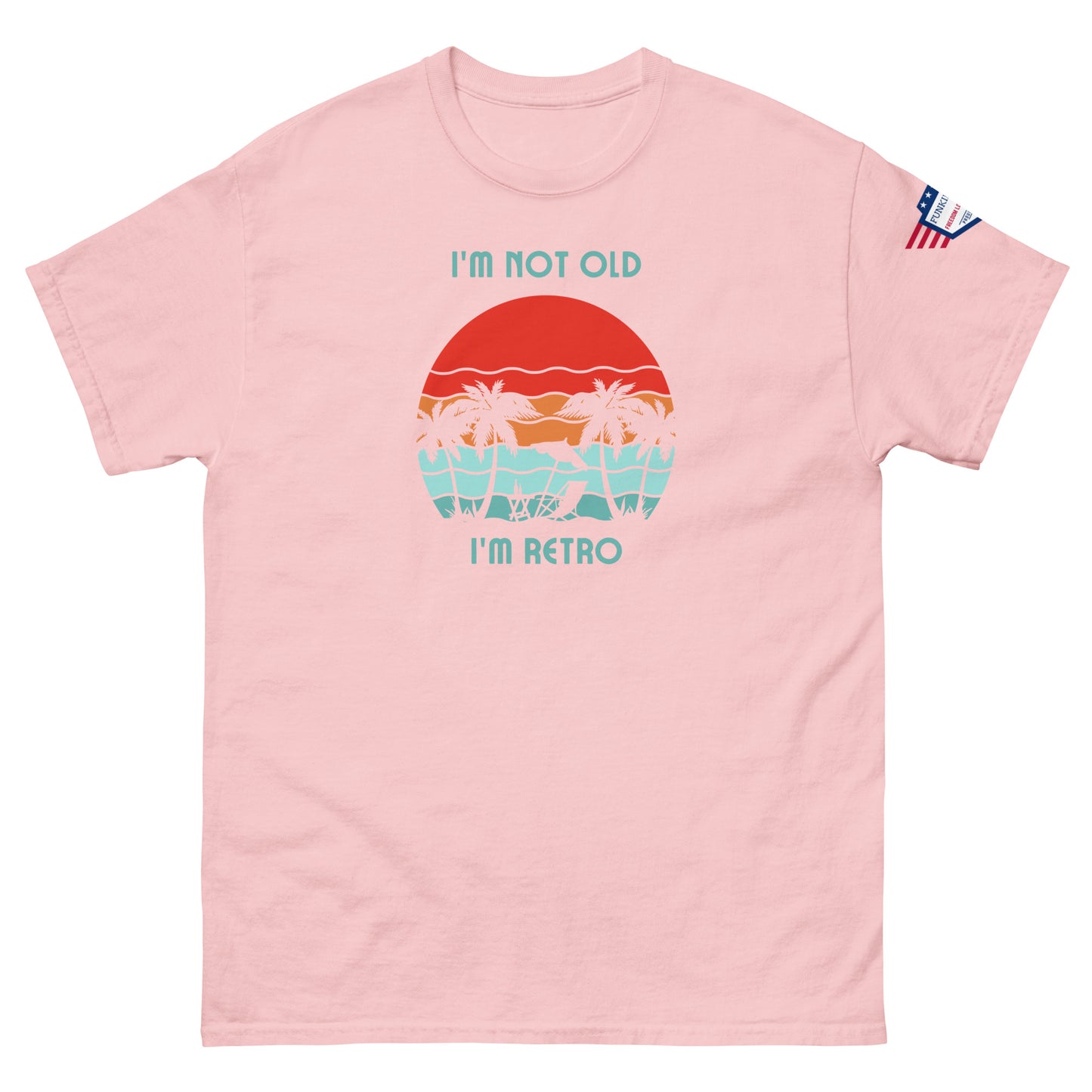 Front view of light pink "I'm Not Old I'm Retro" unisex tee featuring retro sunset graphic and flag sleeve detail