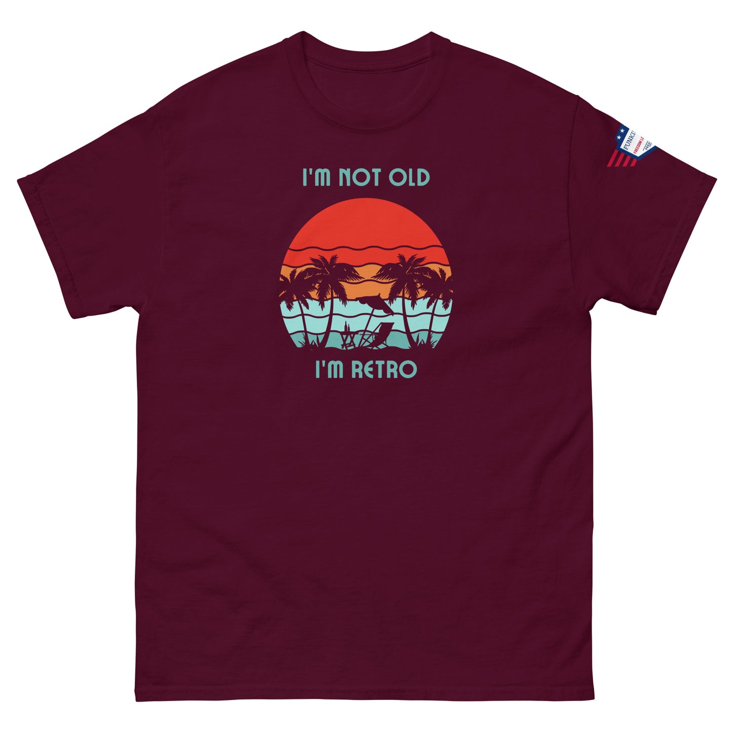 Front view of maroon "I'm Not Old I'm Retro" tee, sunset palms design popping against deep red fabric