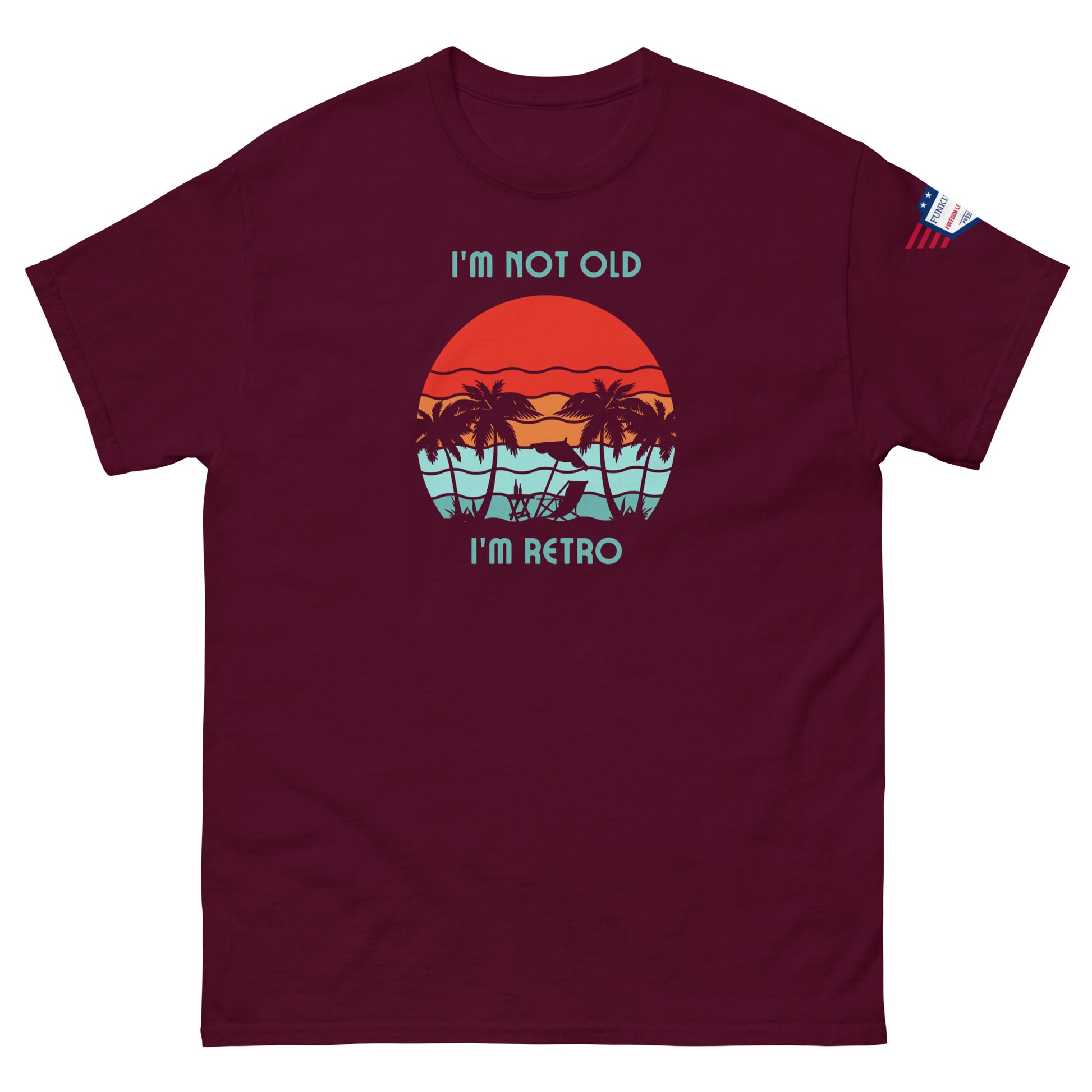 Front view of maroon "I'm Not Old I'm Retro" tee, sunset palms design popping against deep red fabric