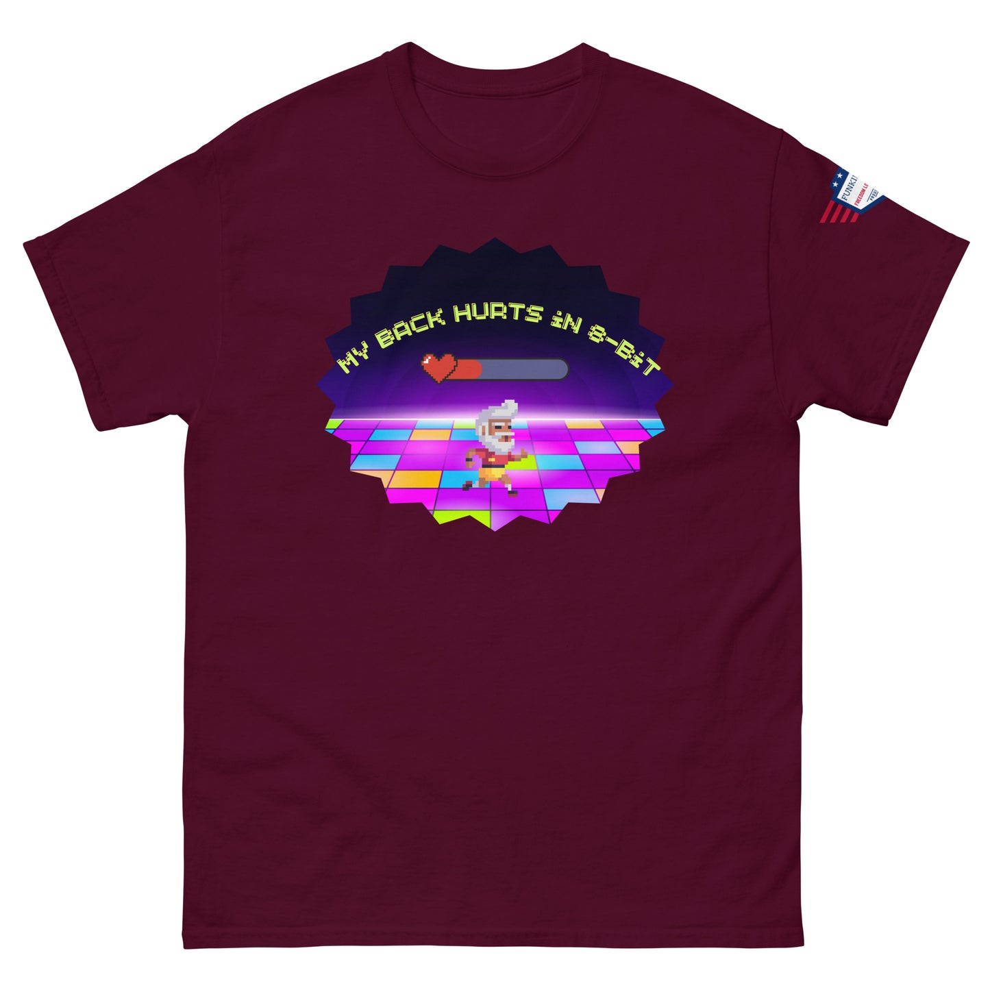 Front view of maroon tee showing "My back hurts so bad" progress bar, 80s chef dancer on colorful floor amid neon starburst, flag patch