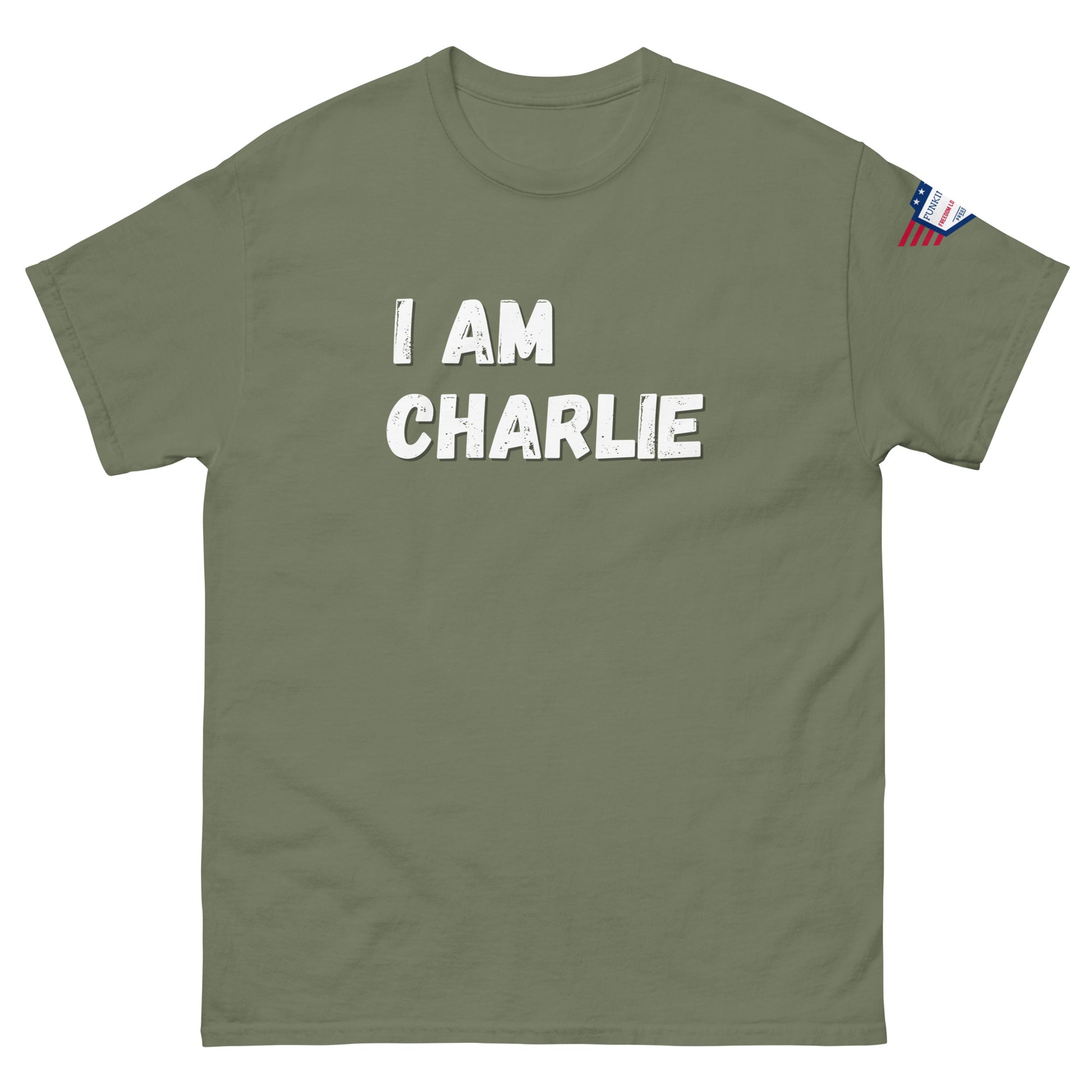 Olive green tee front, bold white "I AM CHARLIE" design, patriotic sleeve flag