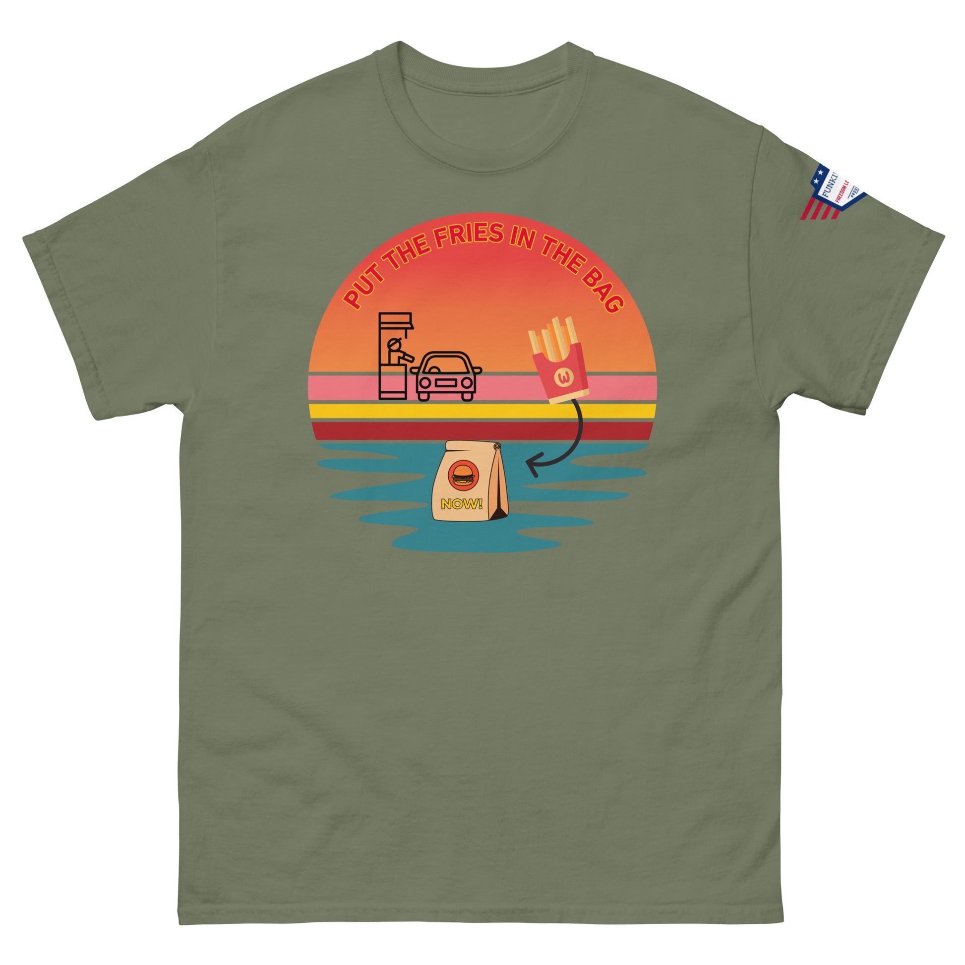 Front view of olive green T-shirt with "PUT THE FRIES IN THE BAG" sunset drive-thru print, McD bag, fries and US flag patch