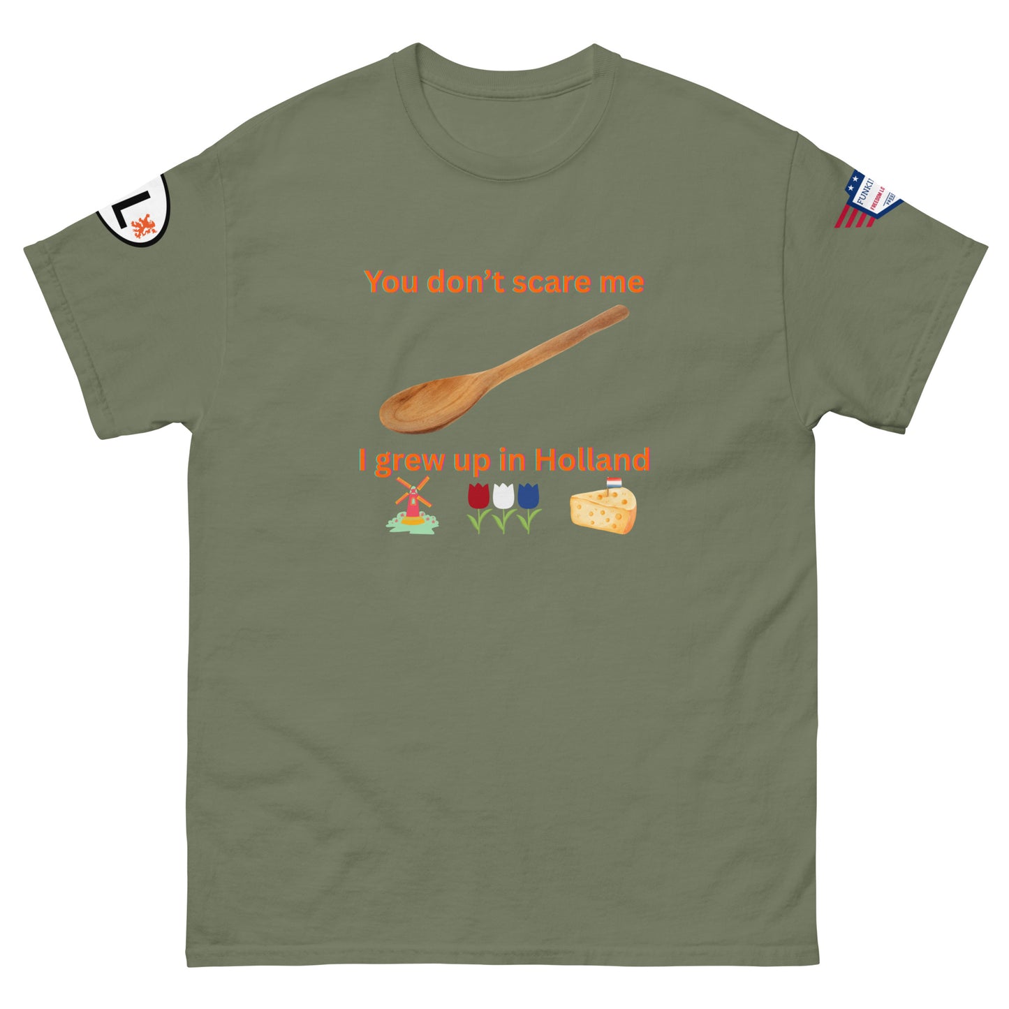 Front view of olive green tee: "You don't scare me, I grew up in Holland" orange design, wooden spoon, Dutch windmill, tulips, cheese