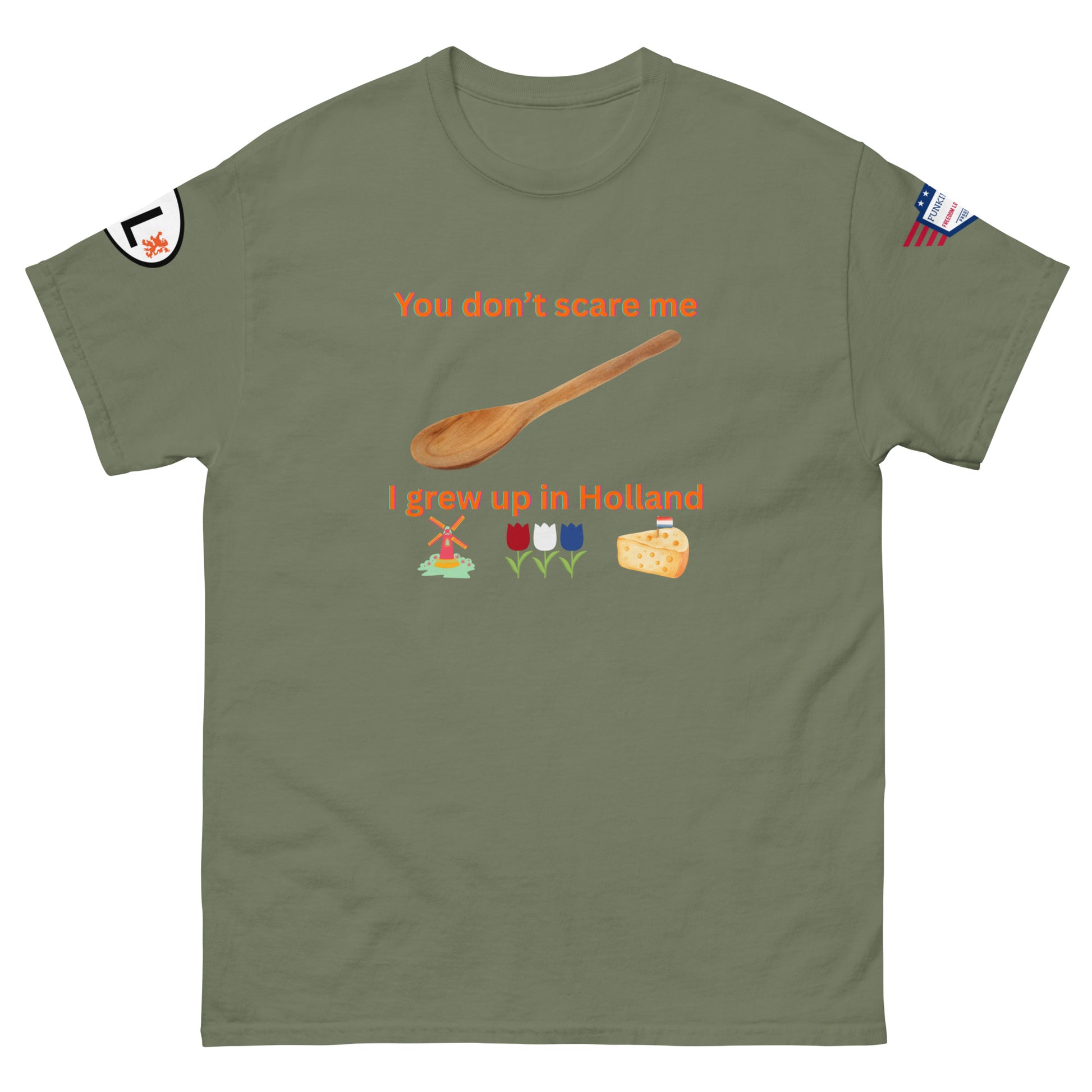 Front view of olive green tee: "You don't scare me, I grew up in Holland" orange design, wooden spoon, Dutch windmill, tulips, cheese