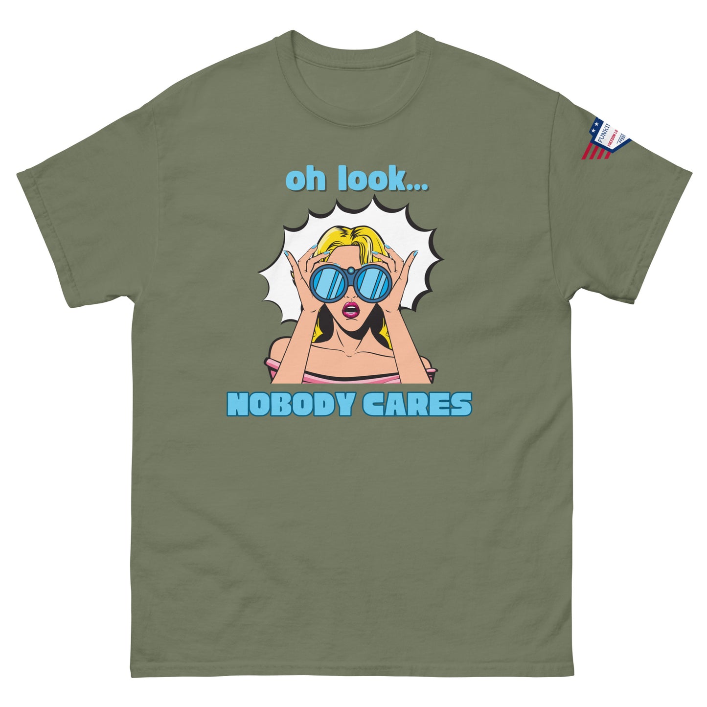 Front view of olive green unisex tee with bold "oh look... NOBODY CARES" pop art and tiny USA flag sleeve patch