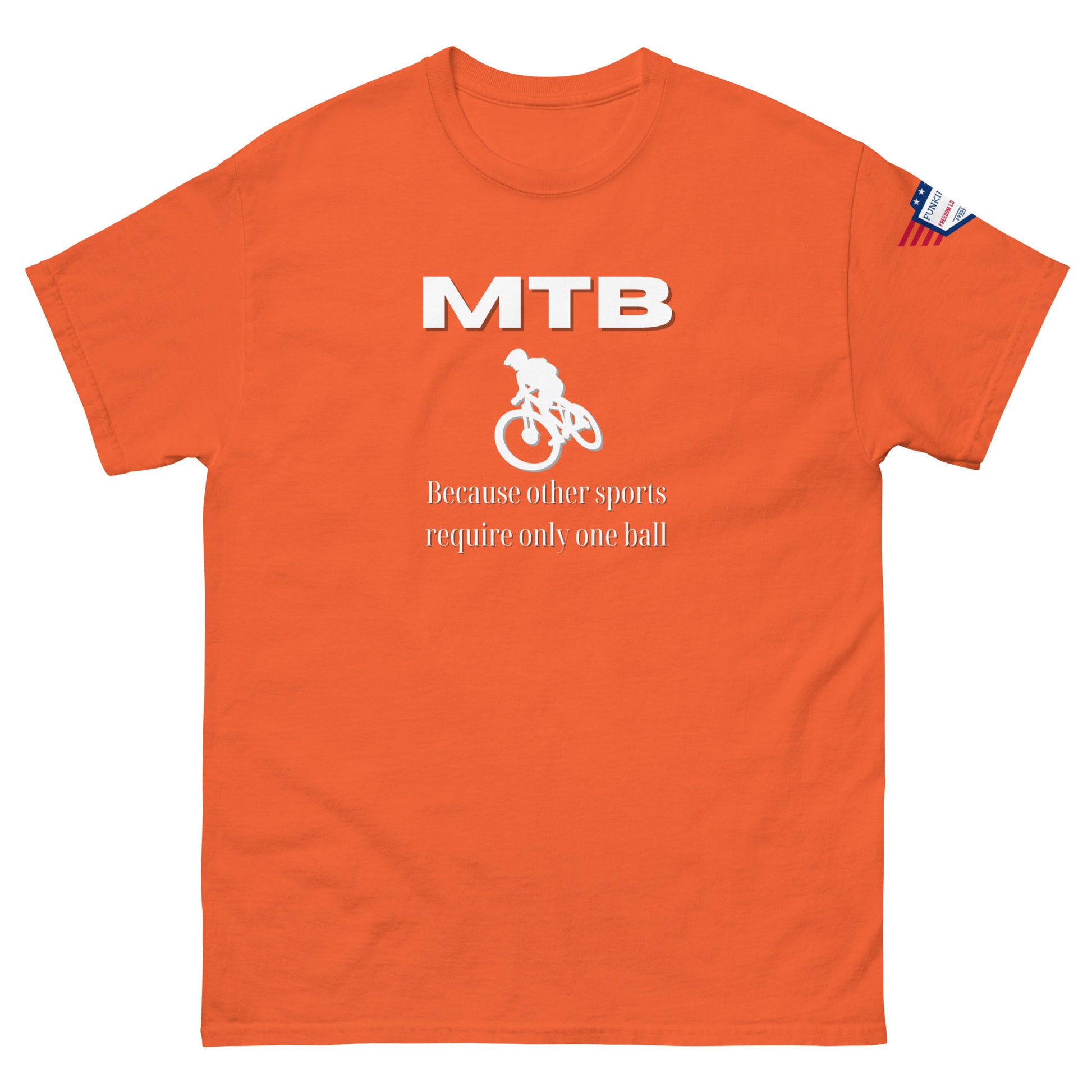 Front view of orange t-shirt with white "MTB" lettering, rider silhouette, "Because other sports require only one ball", flag sleeve tag