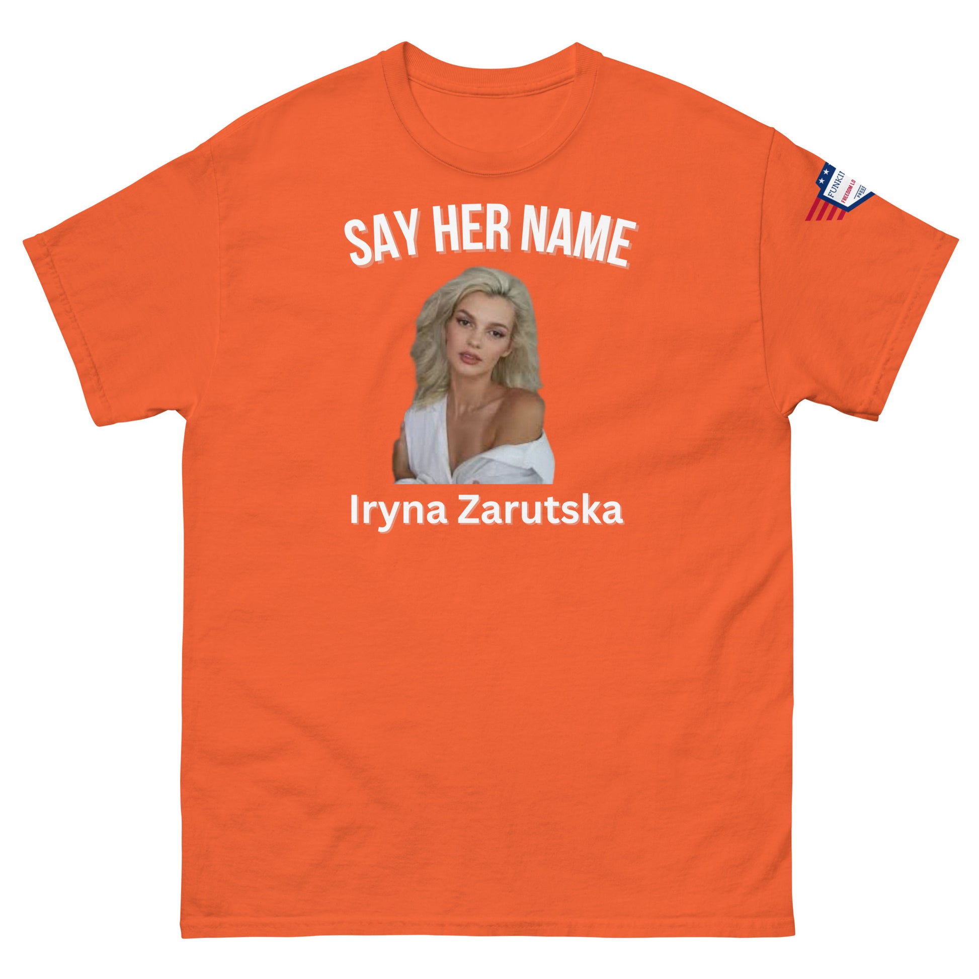Front view of orange classic fit tee with white "SAY HER NAME", Iryna Zarzutska blonde portrait, text and US flag patch