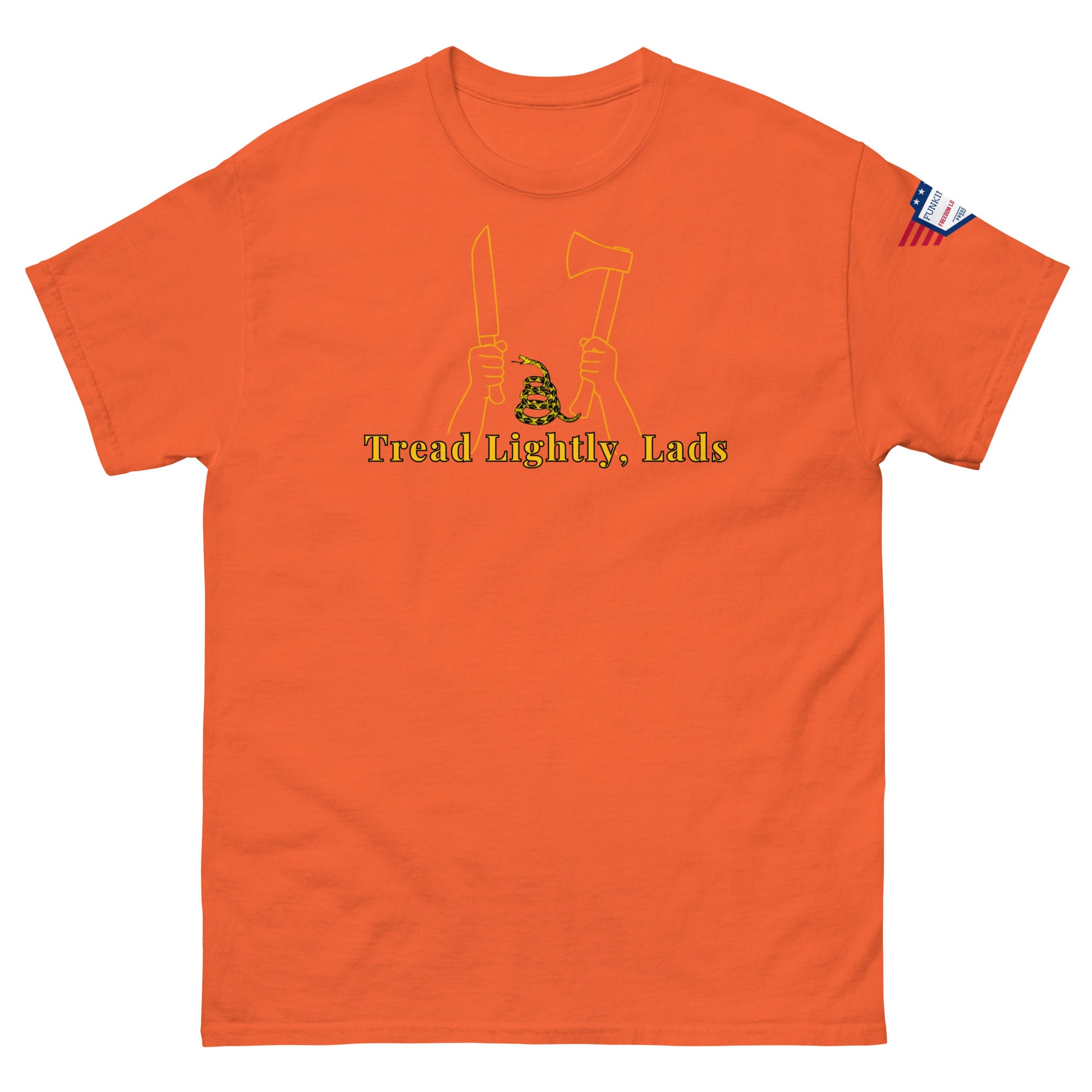 Front view of orange unisex tee displaying "Tread Lightly, Lads" yellow design: knife & axe hands with coiled Gadsden snake, flag patch
