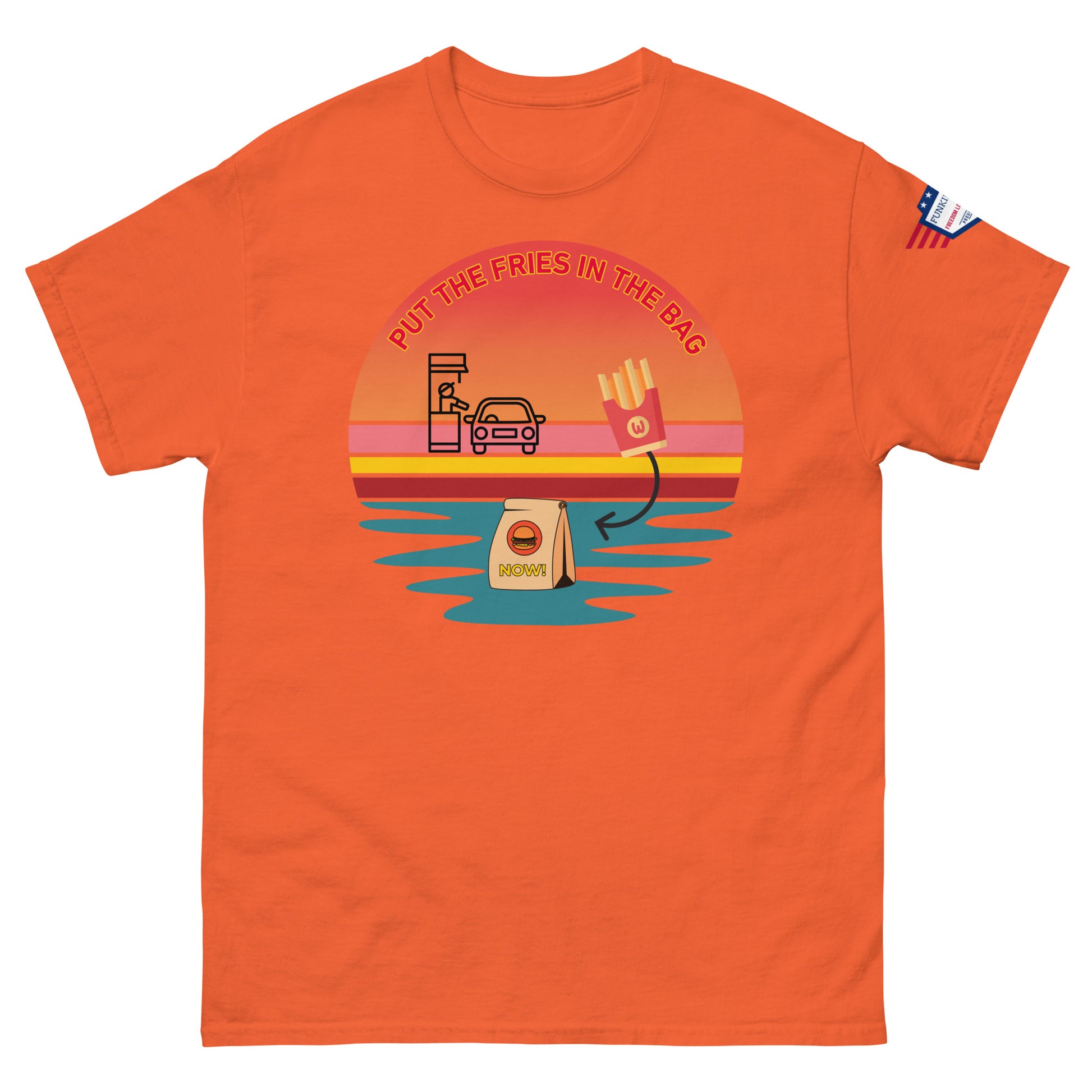 Front view of orange unisex T-shirt with "PUT THE FRIES IN THE BAG" epic drive-thru sunset meme, fries, bag and flag patch