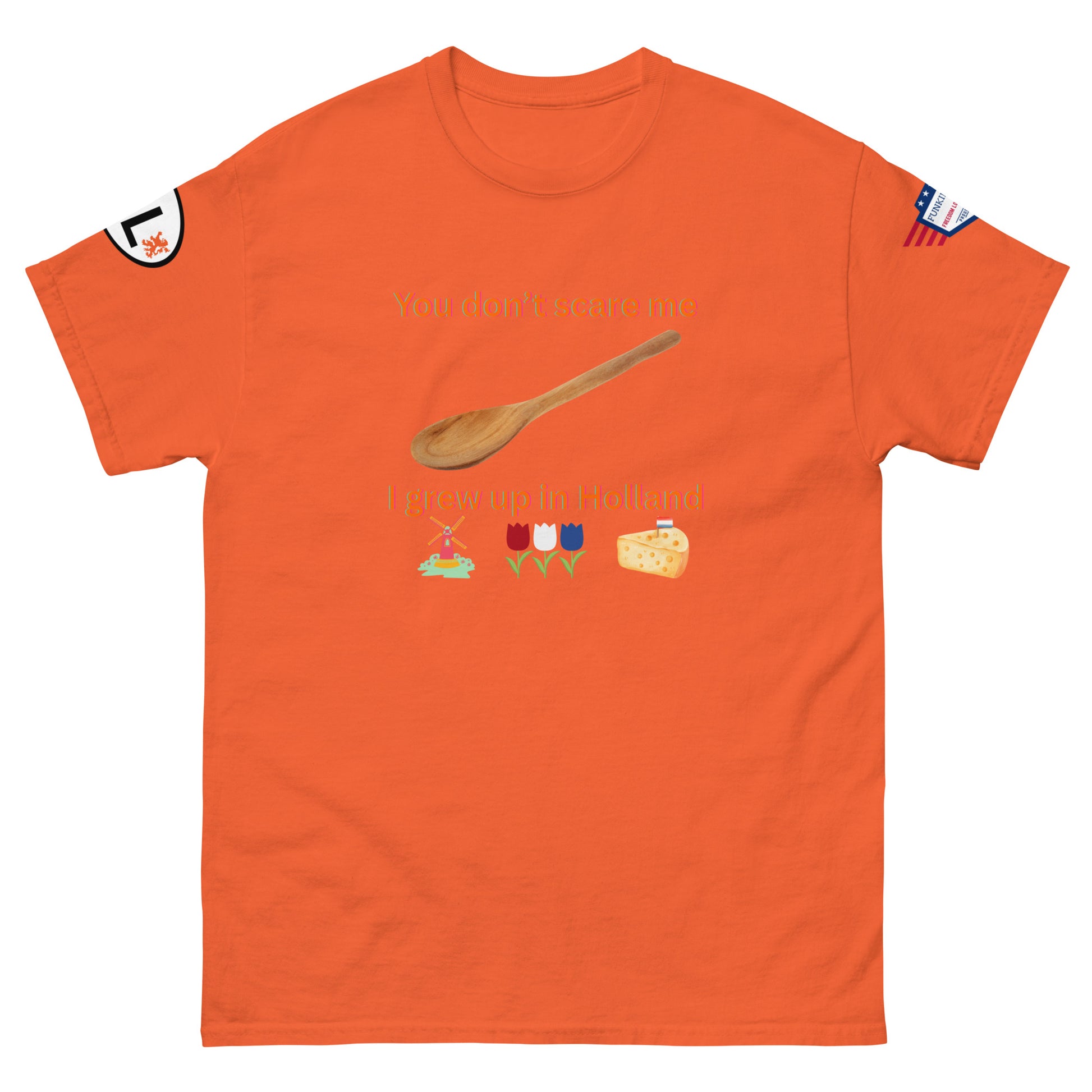 Front view of orange unisex tee with "You don't scare me, I grew up in Holland" text, wooden spoon, Dutch icons: windmill, tulips, cheese