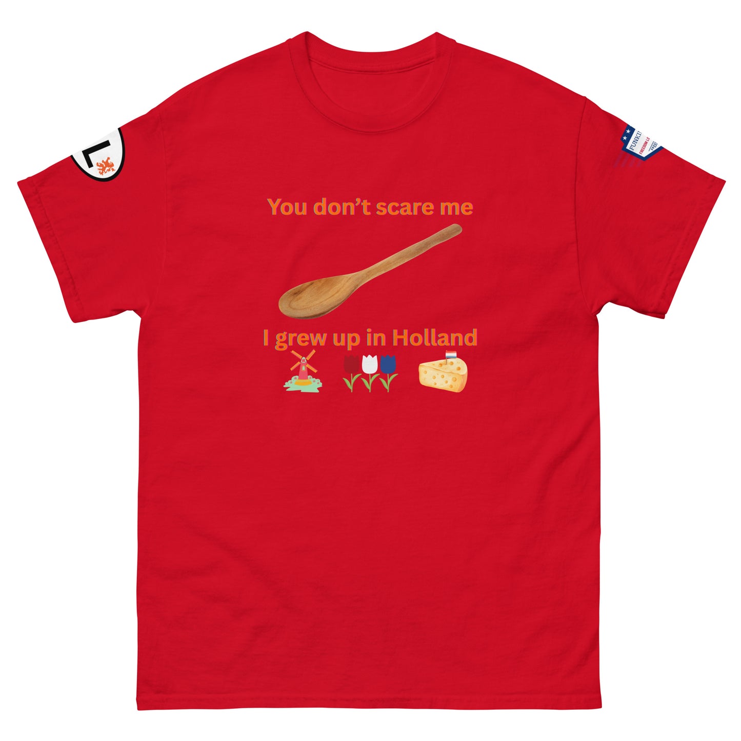 Front view of red unisex tee featuring "You don't scare me, I grew up in Holland" orange print with spoon, windmill, tulips, cheese