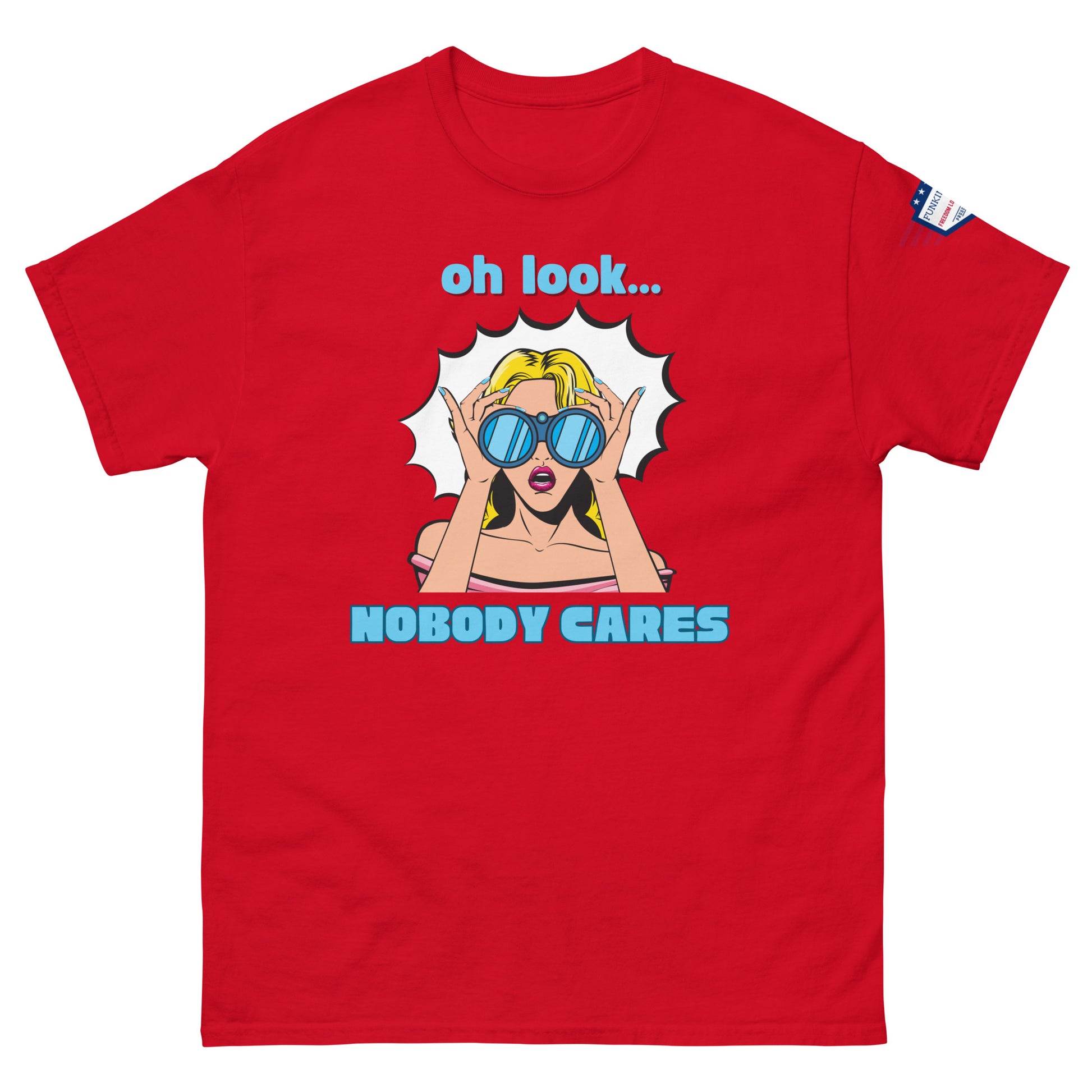 Front view of red unisex t-shirt featuring explosive "oh look... NOBODY CARES" pop-art design, flag on sleeve
