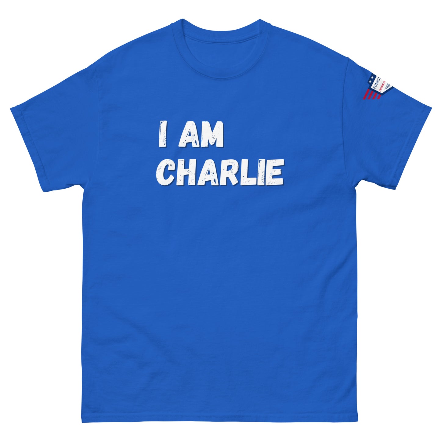 Royal blue tee front, bold white "I AM CHARLIE" print, small US flag patch