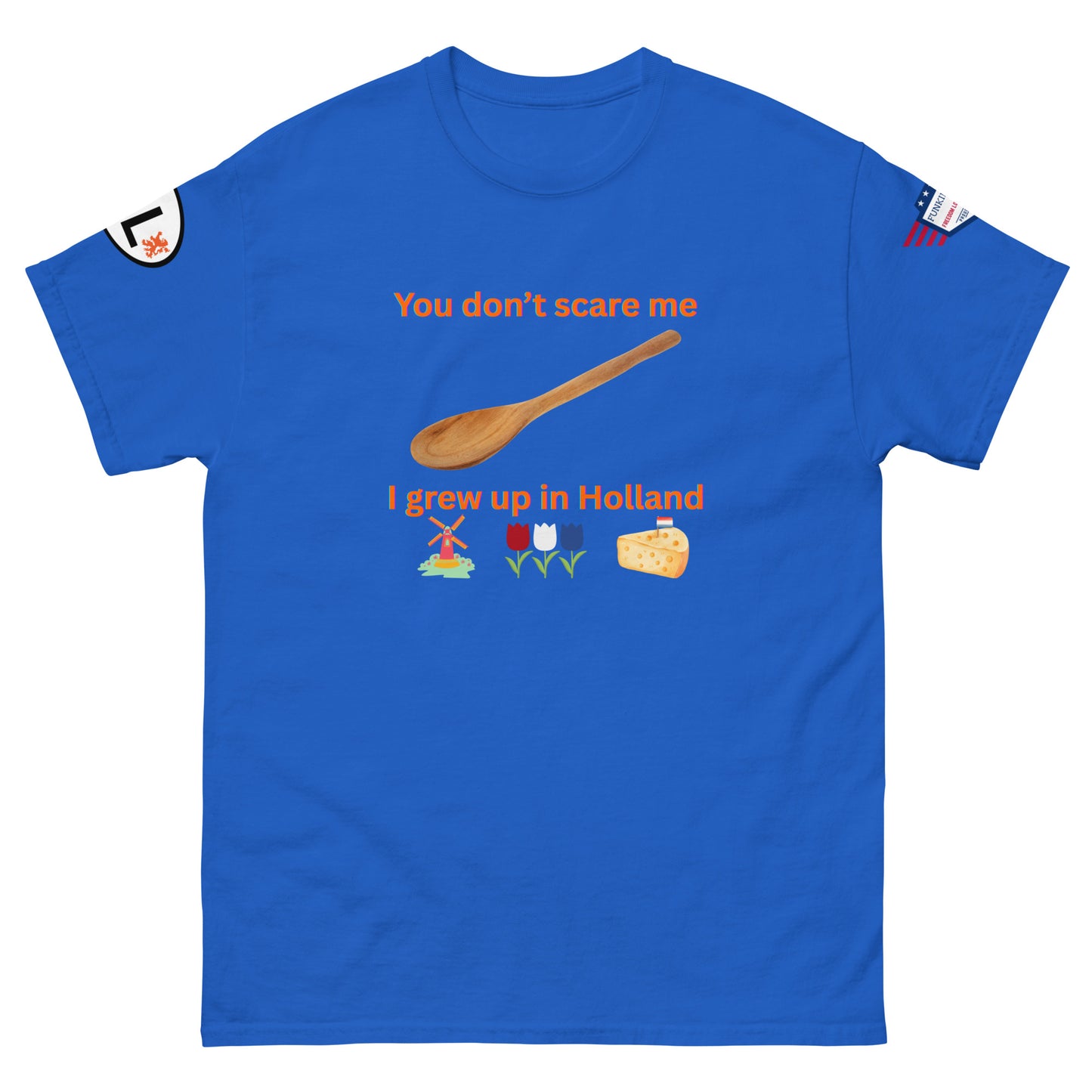 Front view of royal blue tee with "You don't scare me, I grew up in Holland" orange design, wooden spoon, Dutch windmill, tulips, cheese