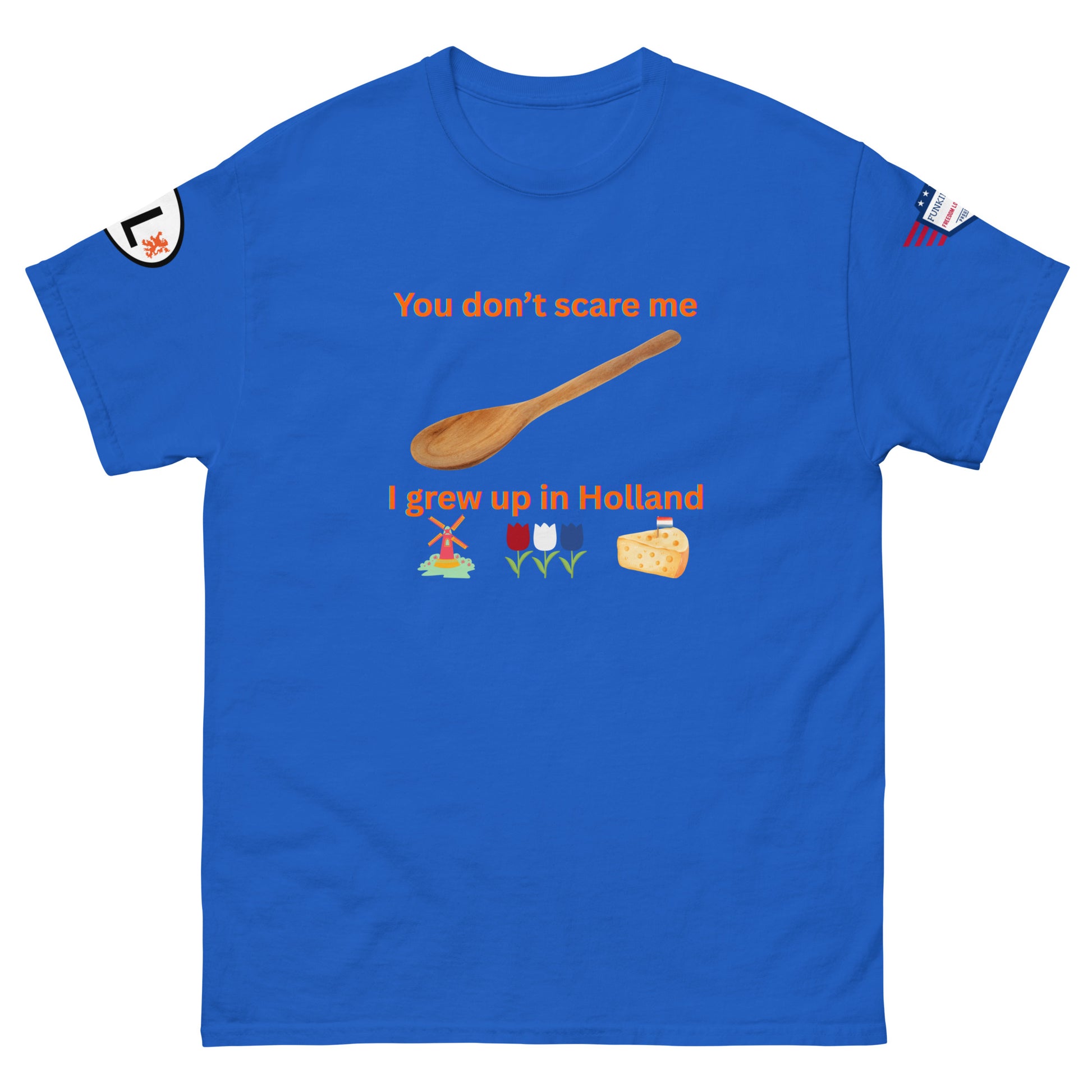 Front view of royal blue tee with "You don't scare me, I grew up in Holland" orange design, wooden spoon, Dutch windmill, tulips, cheese