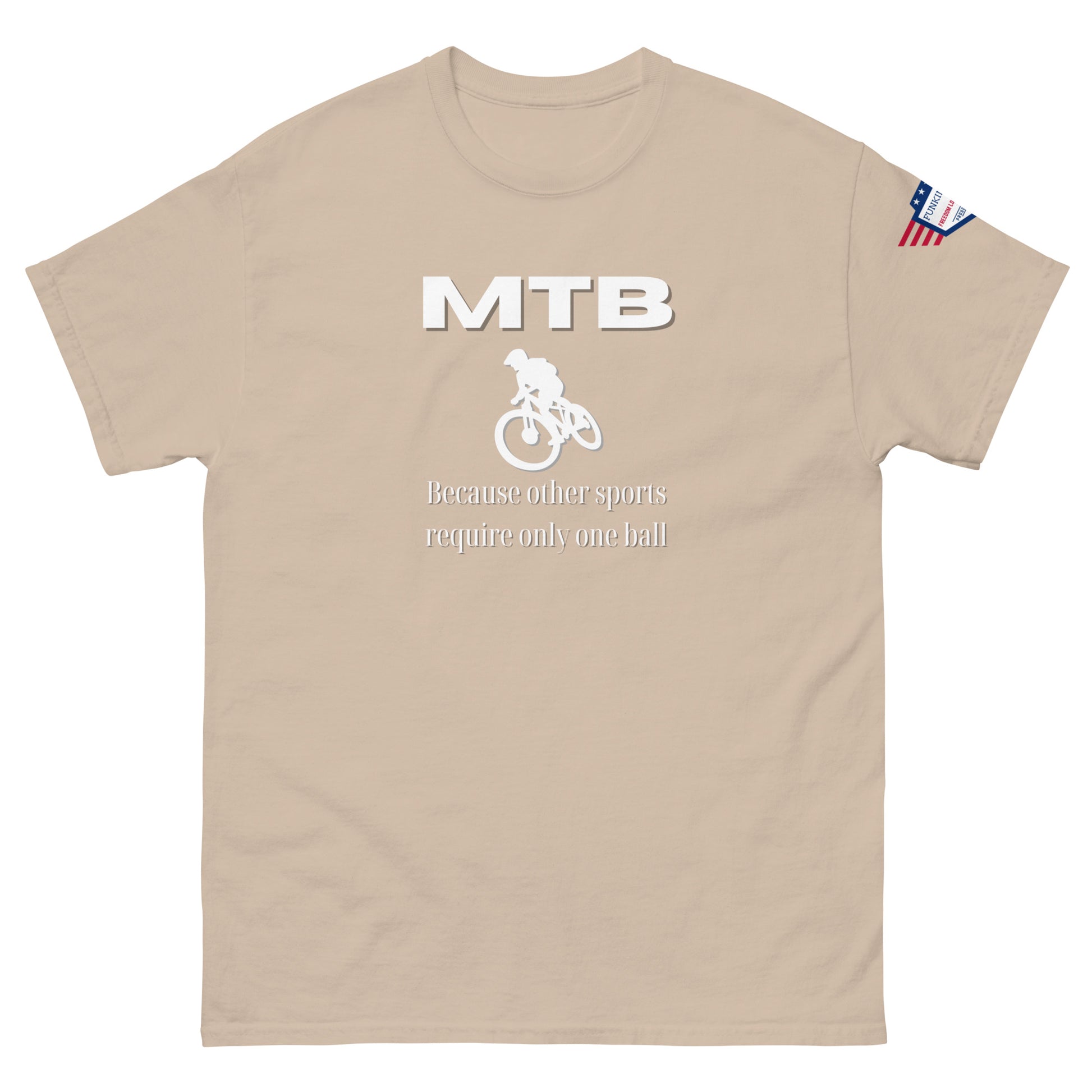 Front view of sand beige t-shirt showing white "MTB", rider graphic, "Because other sports require only one ball", flag sleeve patch