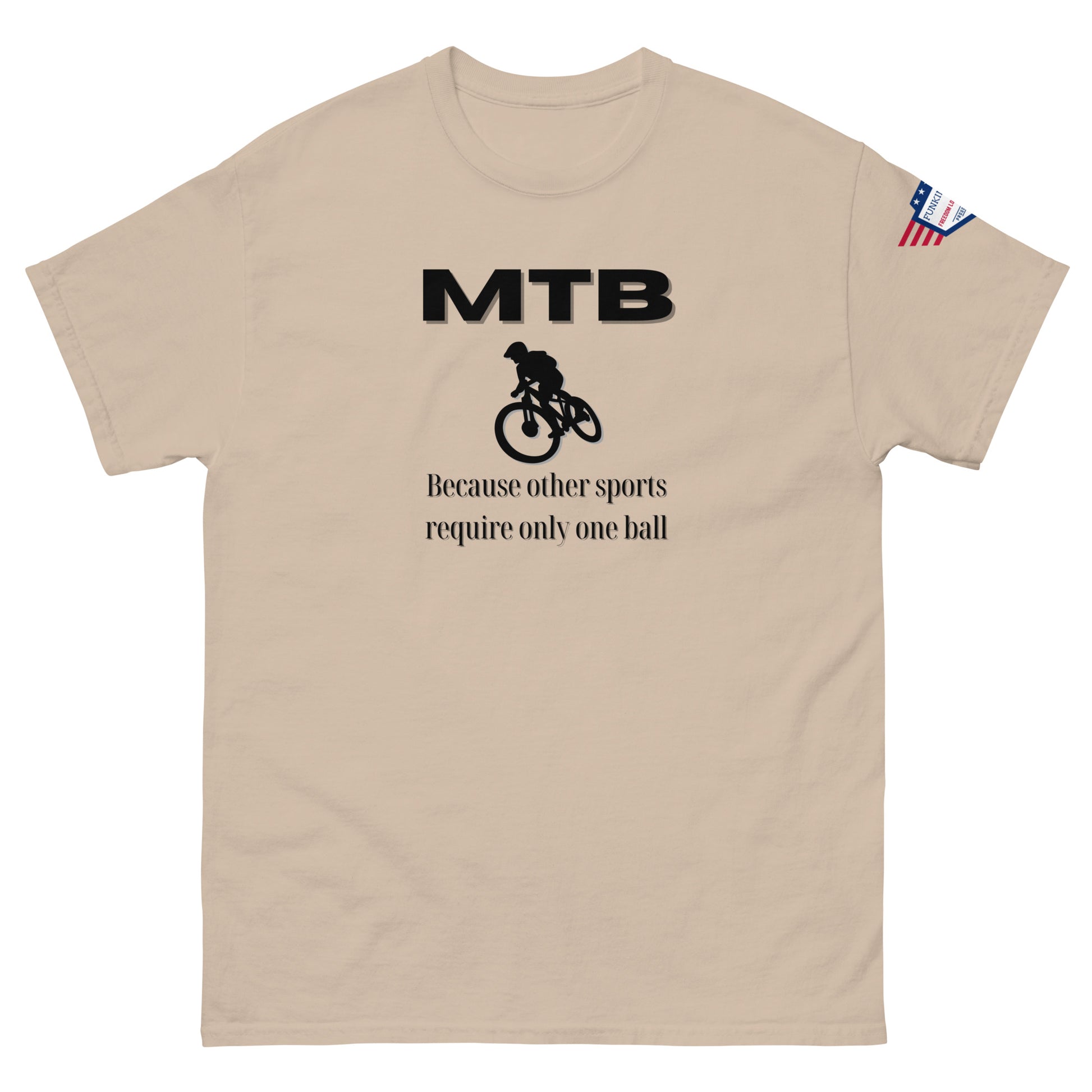 Sand beige t-shirt front: black "MTB" logo, cyclist graphic, "Because other sports require only one ball" jab