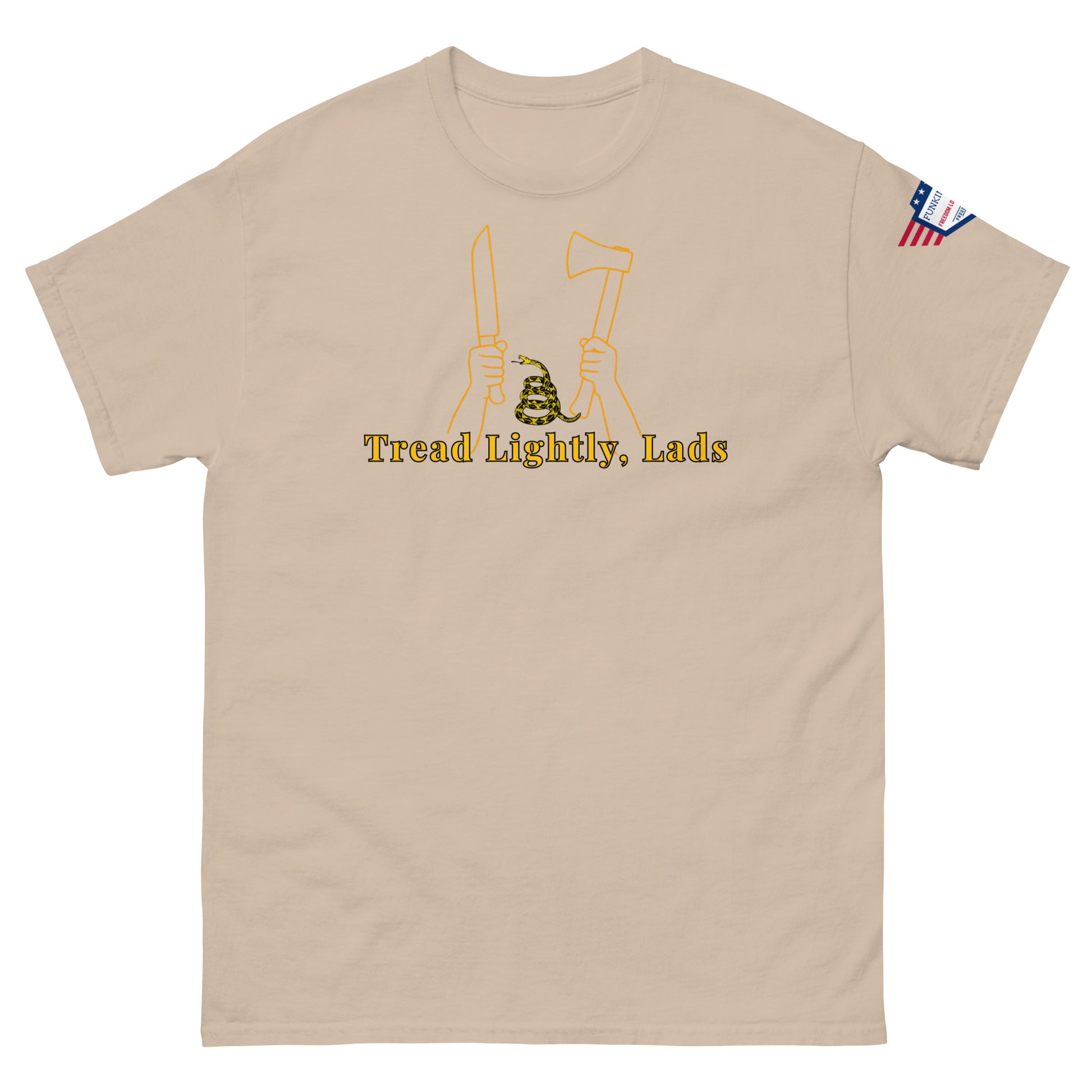 Front view of sand tan unisex tee showing "Tread Lightly, Lads" yellow print, armed hands & coiled snake design, US flag sleeve label