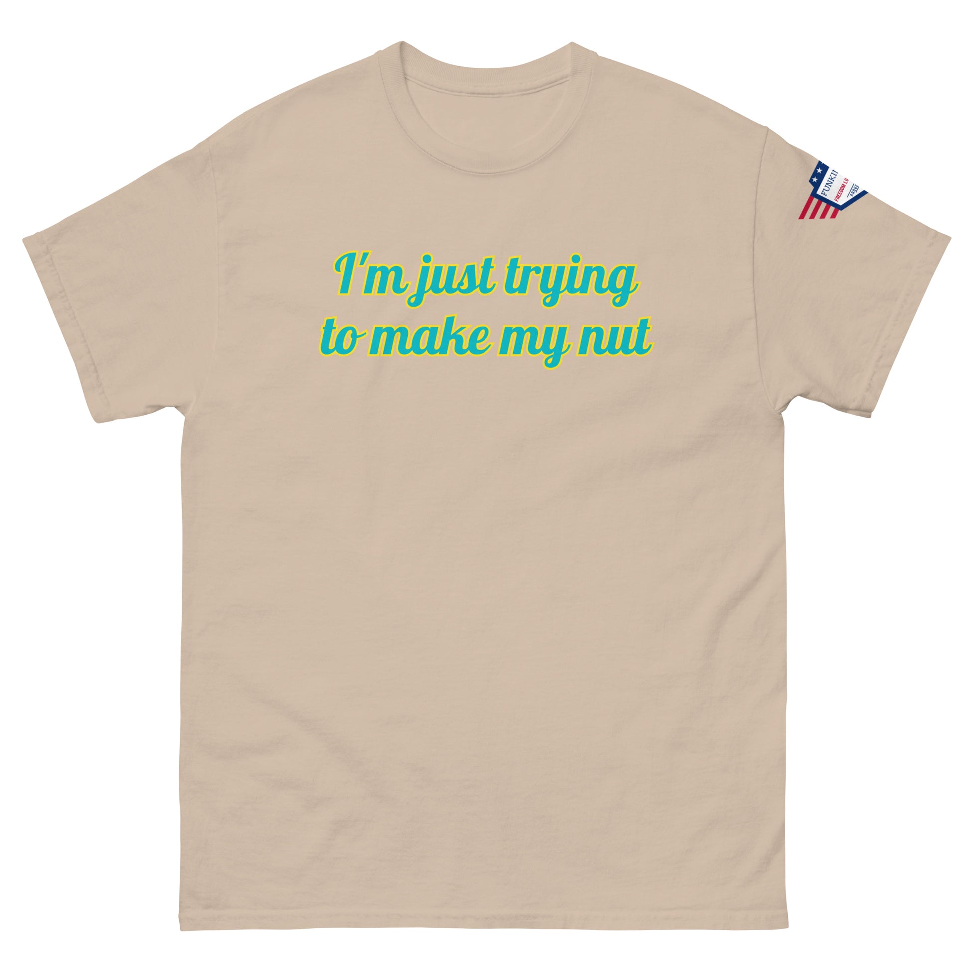 Front view of tan tee with "I'm just trying to make my nut" in teal script and US flag sleeve patch