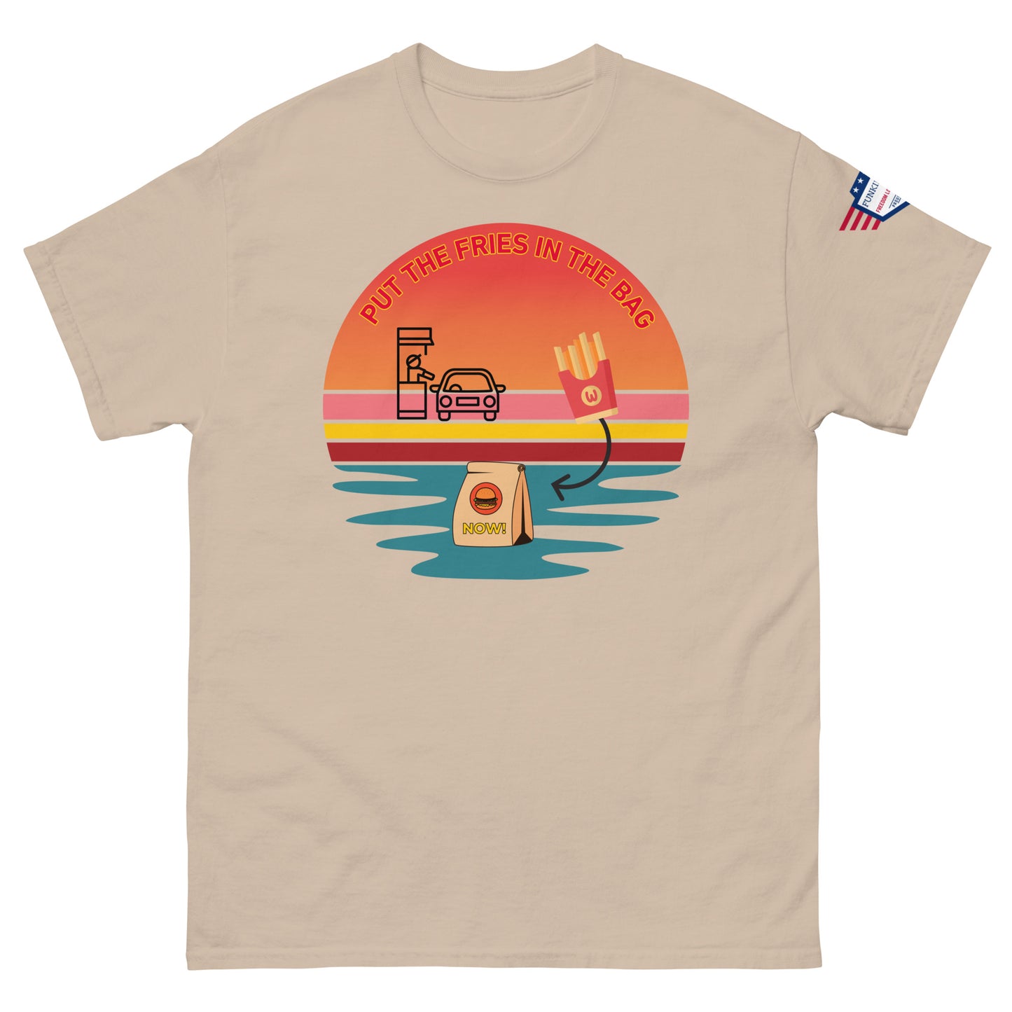 Front view of beige unisex T-shirt with "PUT THE FRIES IN THE BAG" drive-thru sunset print and subtle US flag sleeve patch