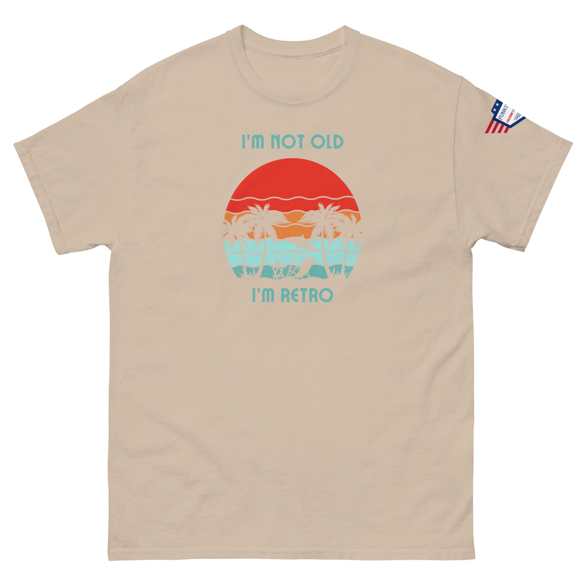 Front view of tan "I'm Not Old I'm Retro" tee with sunset hammock design and USA flag patch