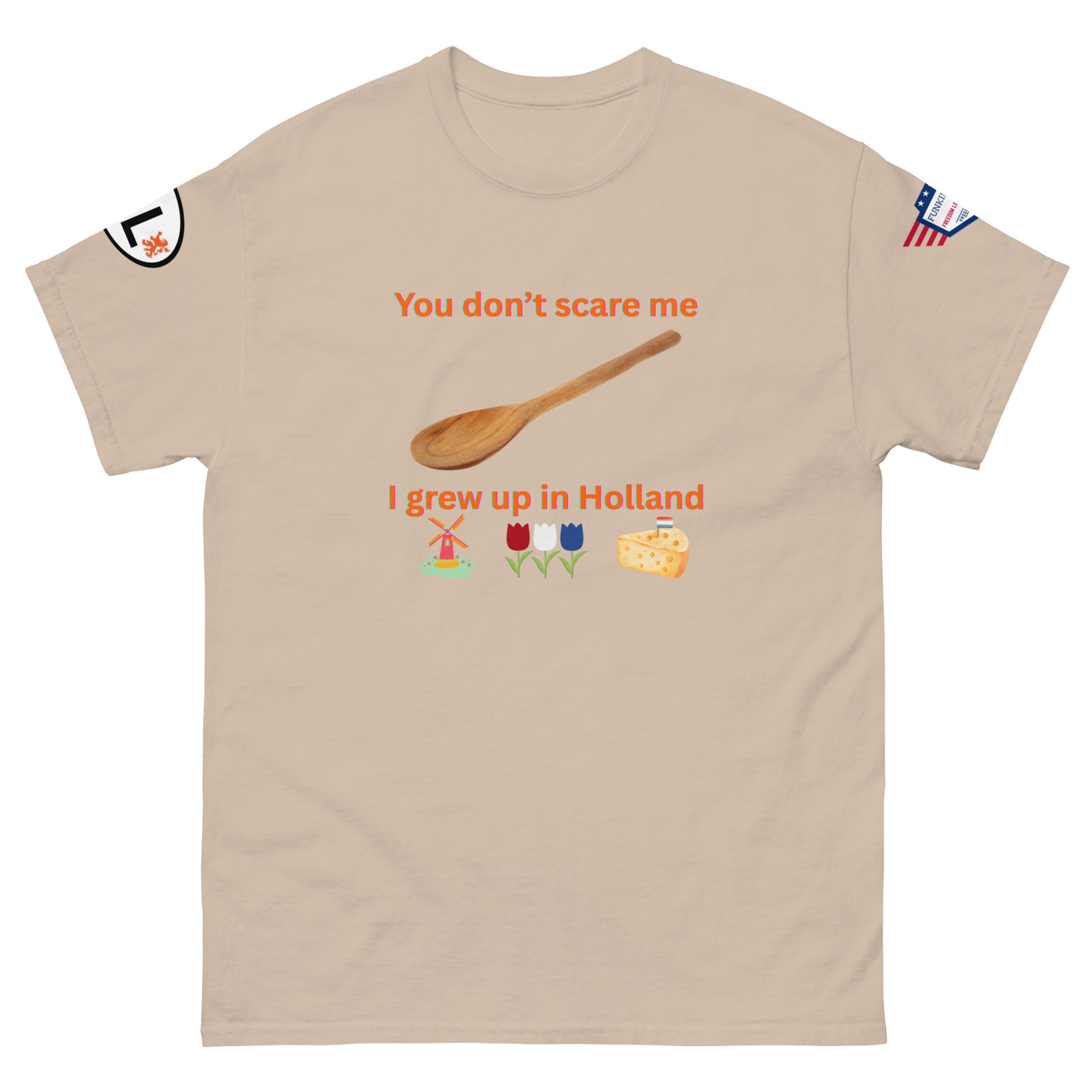 Front view of sand beige tee showing orange "You don't scare me, I grew up in Holland", spoon, windmill, tulips & cheese emojis