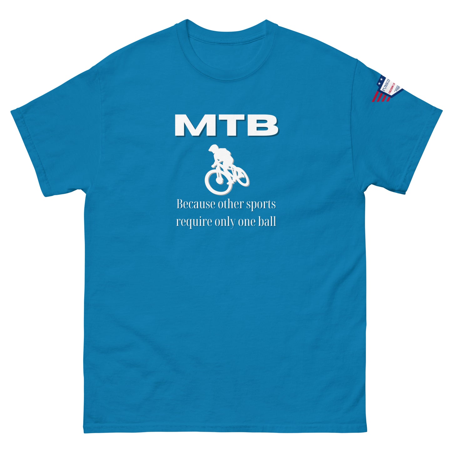 Front view of medium blue unisex tee featuring white "MTB" text, cyclist graphic, "Because other sports require only one ball", flag patch