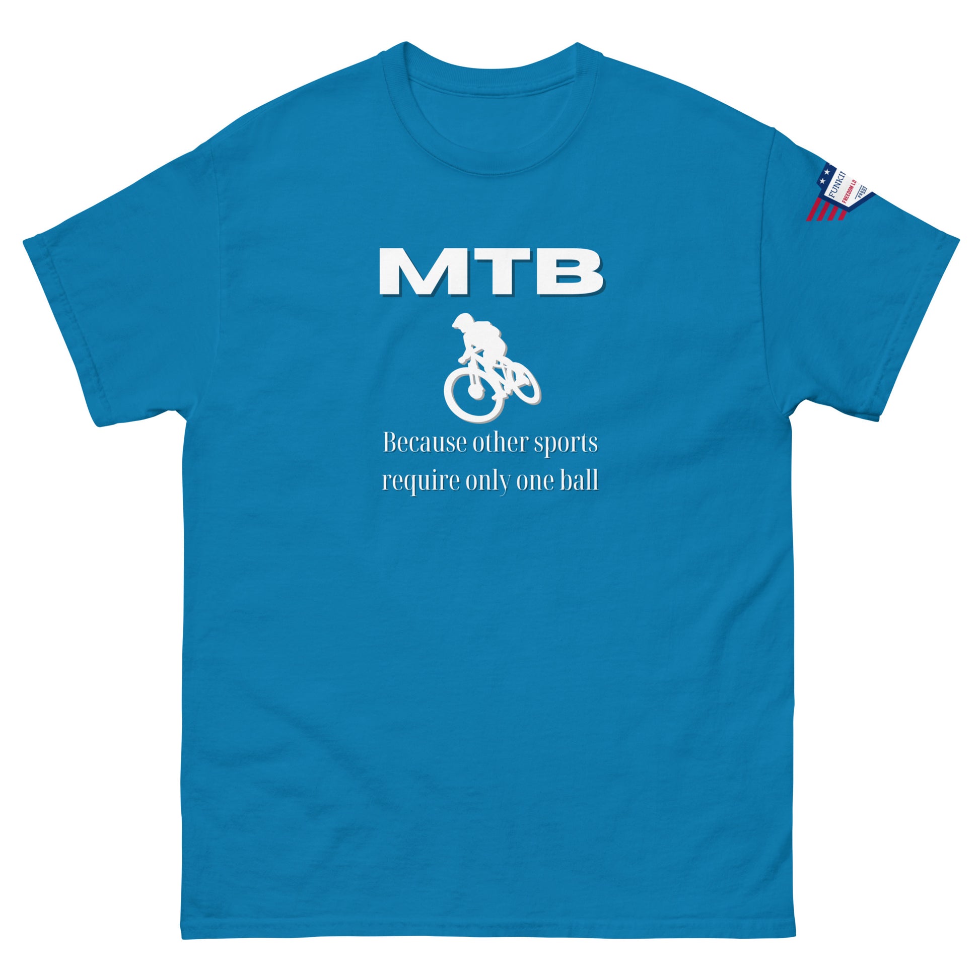 Front view of medium blue unisex tee featuring white "MTB" text, cyclist graphic, "Because other sports require only one ball", flag patch