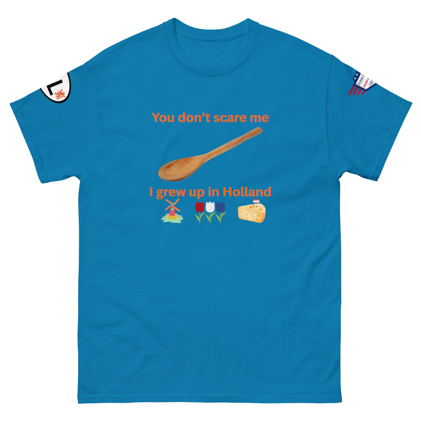 Front view of sky blue unisex tee with "You don't scare me I grew up in Holland" orange graphic, wooden spoon, windmill, tulips, cheese, sleeve tags