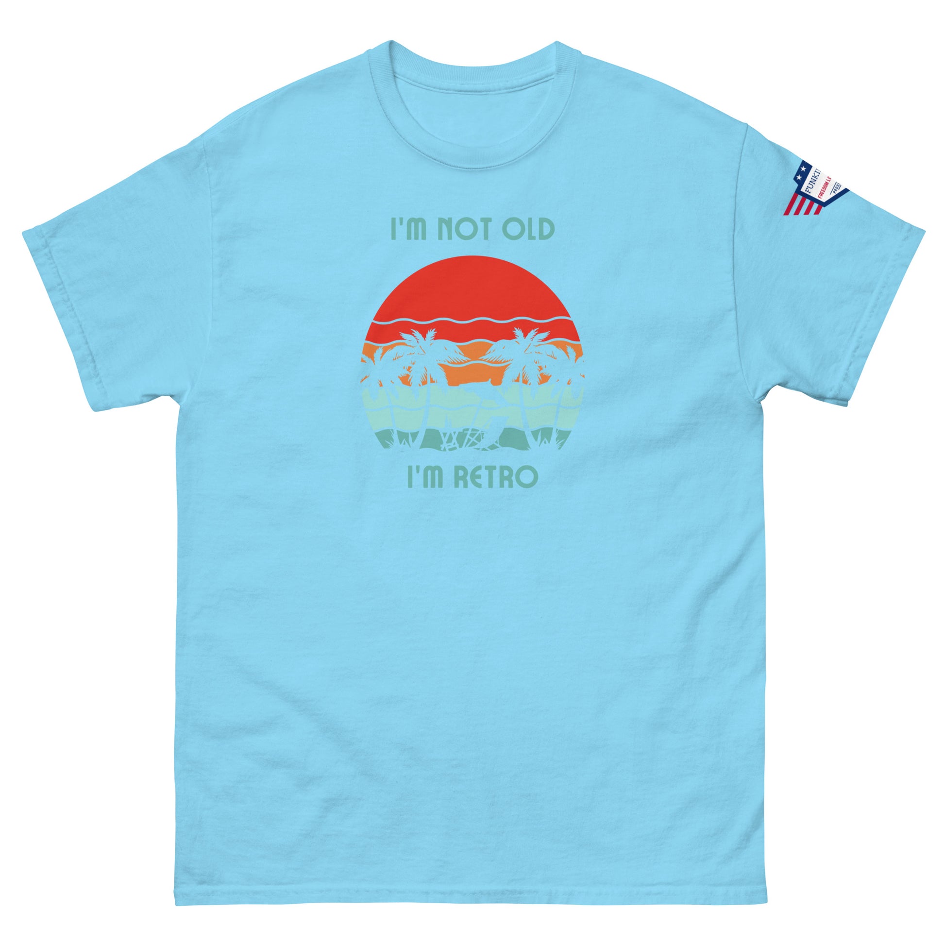 Front view of light blue unisex t-shirt with "I'm not old I'm retro" text over red sun, sunset waves, palms graphic