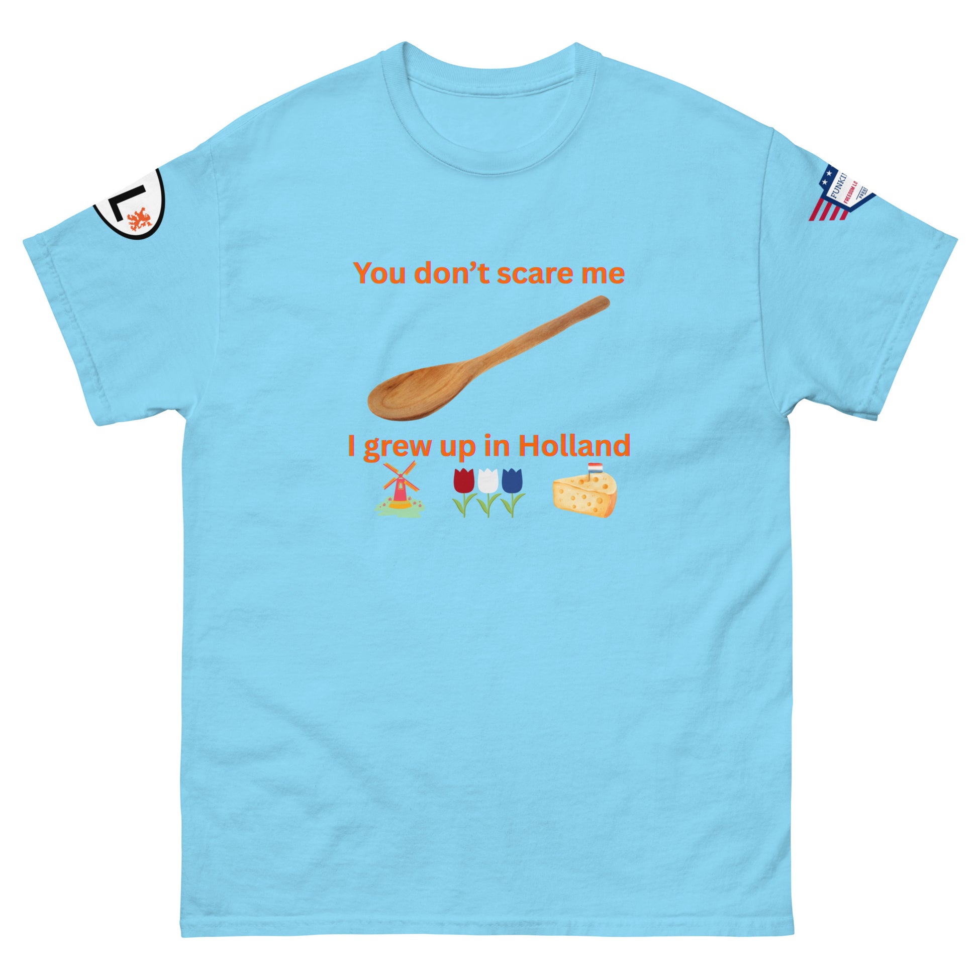 Front view of cyan unisex tee with orange "You don't scare me I grew up in Holland" print, wooden spoon, windmill, tulips, cheese emojis, sleeve patches