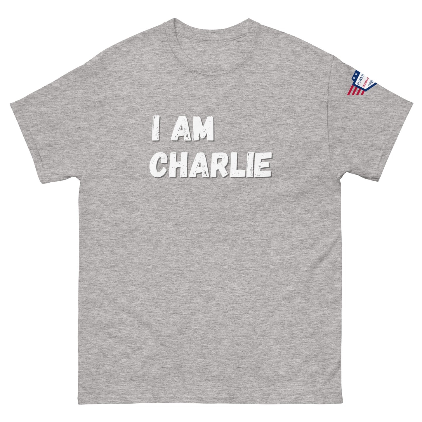 Front view of light heather gray unisex tee with bold white "I AM CHARLIE" graphic and USA flag sleeve patch