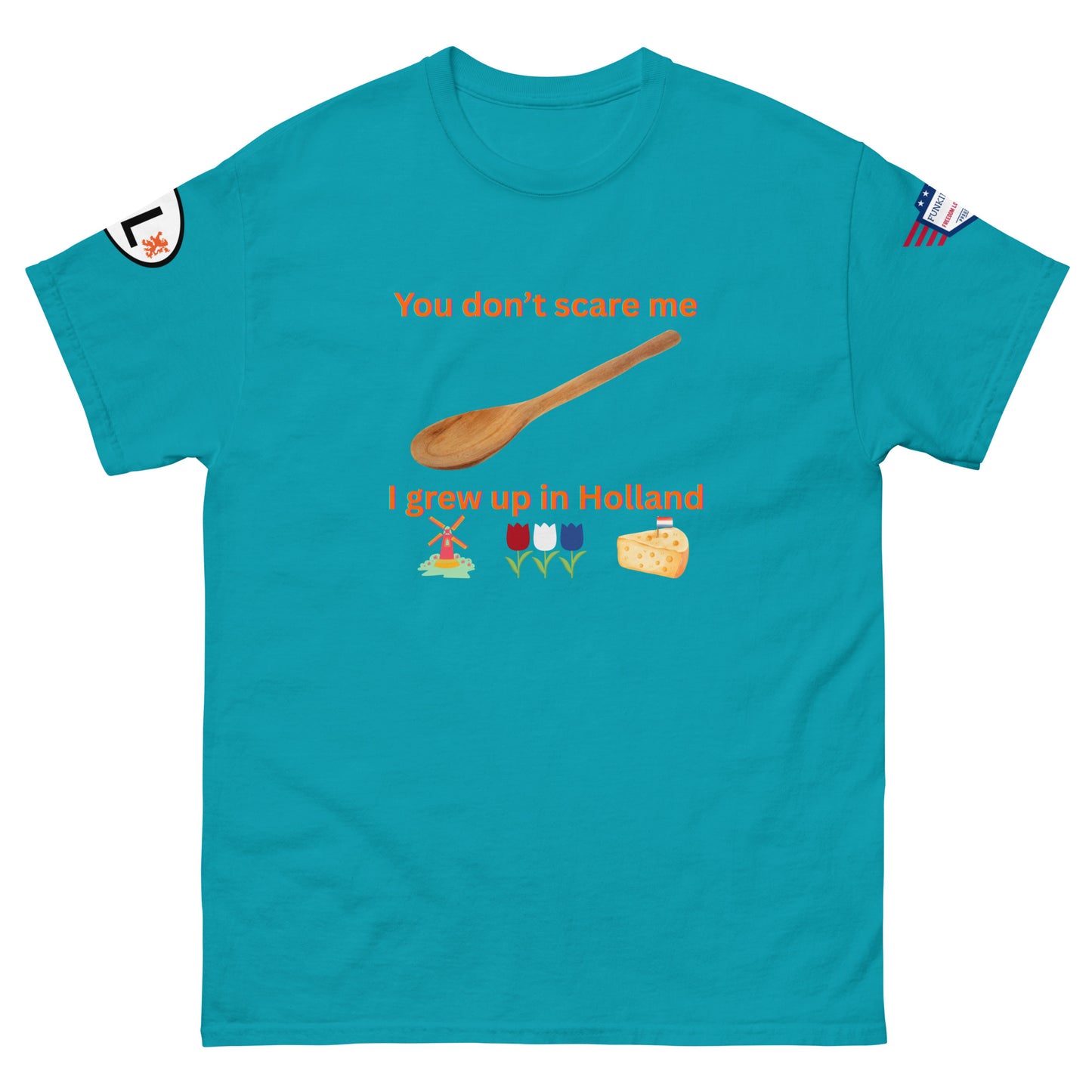 Front view of teal unisex tee featuring "You don't scare me I grew up in Holland" print, wooden spoon, windmill, tulips, cheese emojis, sleeve patches