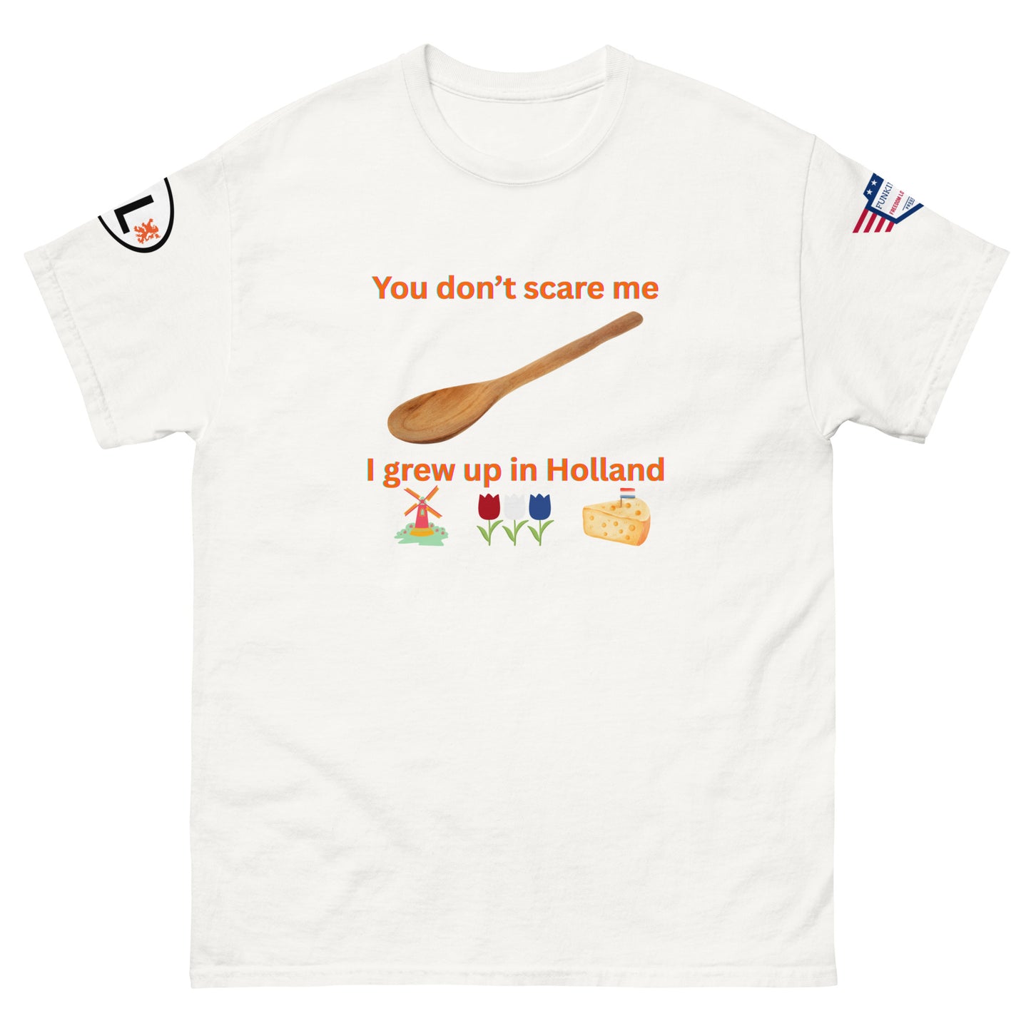 Front view of white unisex tee with bold orange "You don't scare me I grew up in Holland" graphic, spoon, colorful windmill, tulips, cheese, sleeve patches