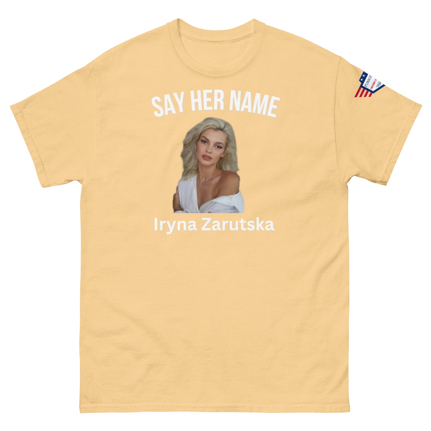 Front view of tan "SAY HER NAME Iryna Zarzutska" meme tee, USA flag sleeve patch