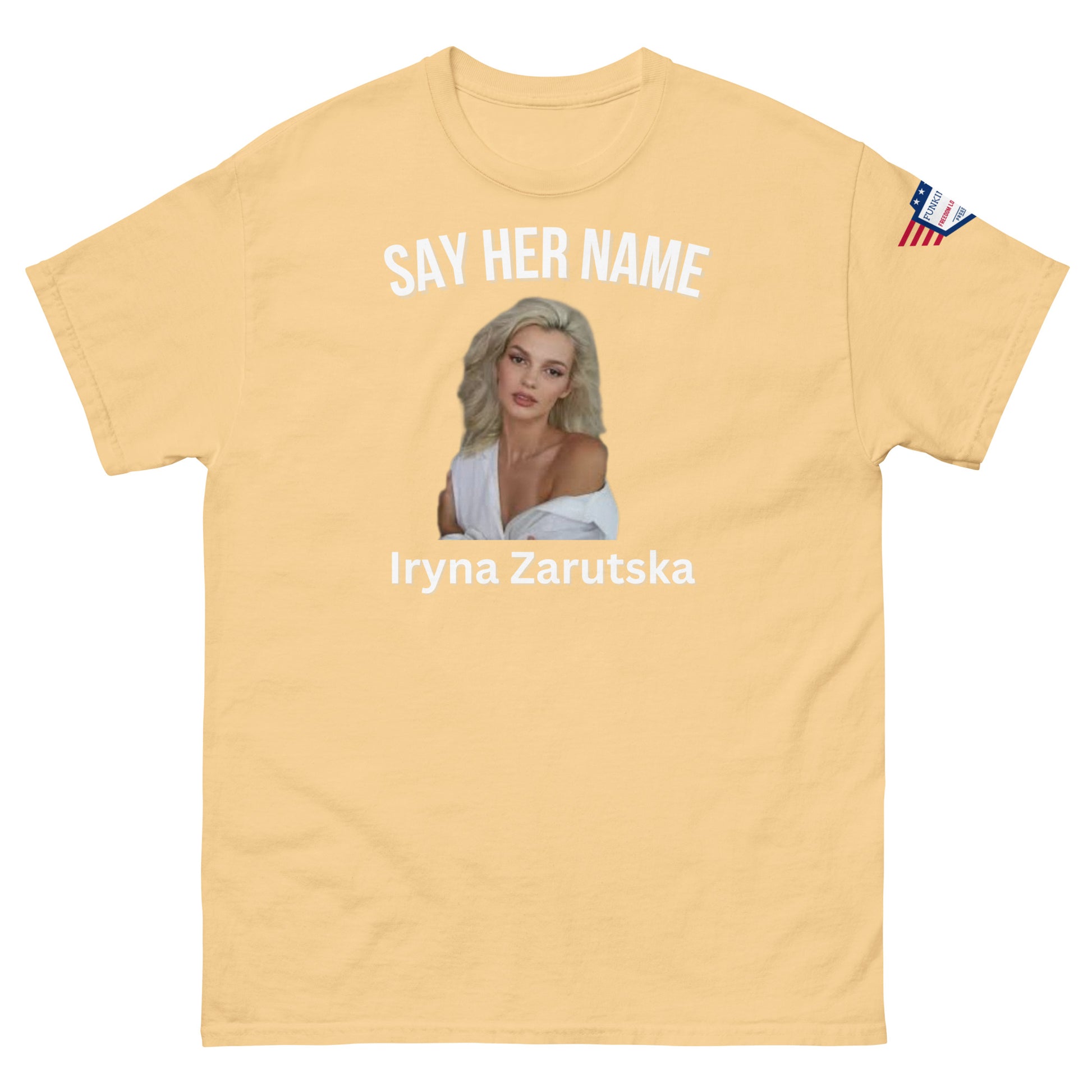 Front view of tan "SAY HER NAME Iryna Zarzutska" meme tee, USA flag sleeve patch