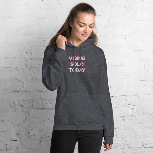 Model smiling in front view of heather gray hoodie with stacked pink "VIBING SOLO TODAY" embroidery