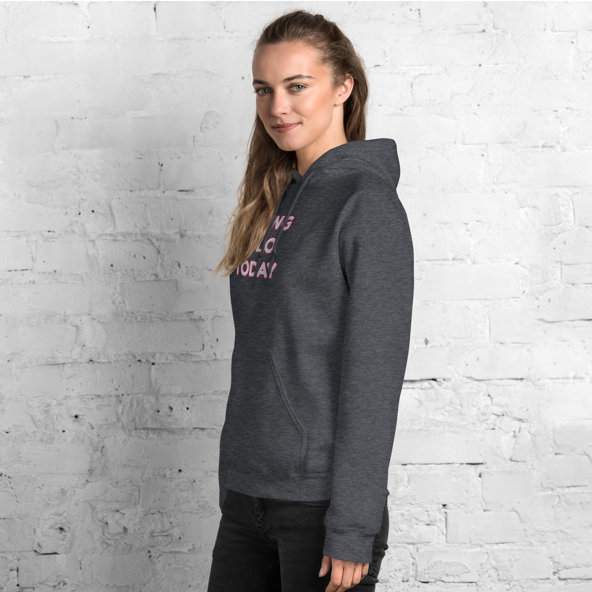 Left side view of model in heather gray hoodie showing partial pink "VIBING SOLO TODAY" embroidery