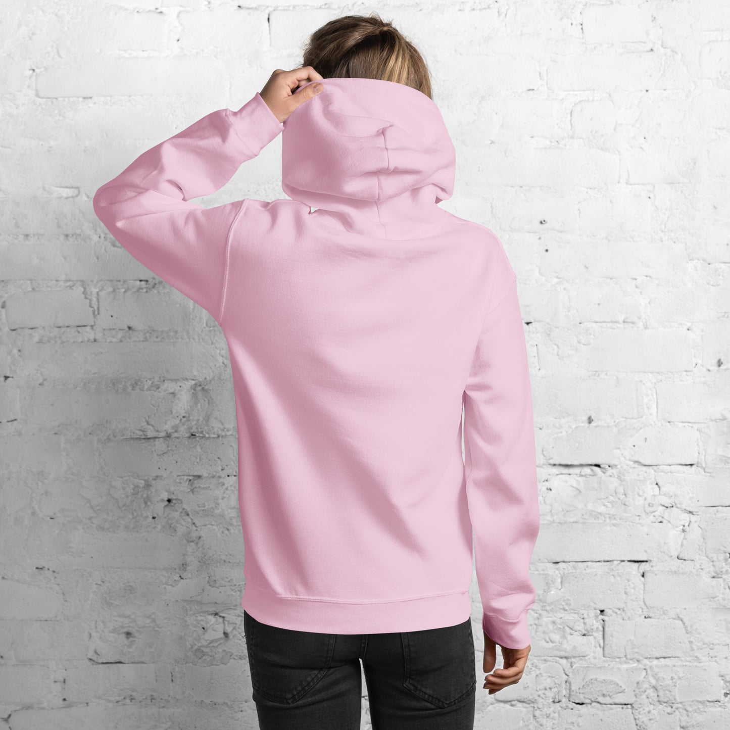 Back view of woman in bright pink hoodie, hood up slightly, hand gesturing