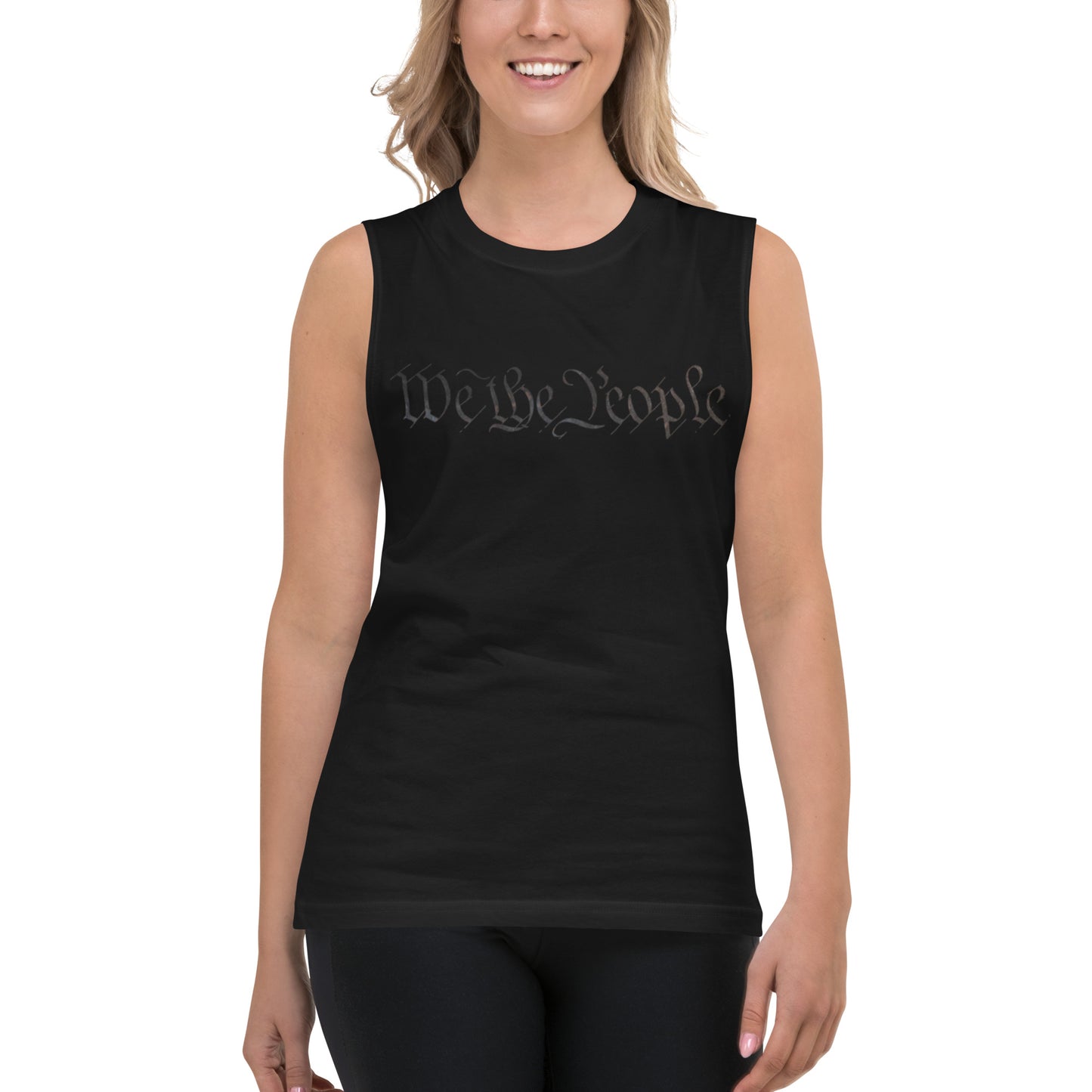 Smiling female model in front-facing black muscle tank with gray cursive "We the People"