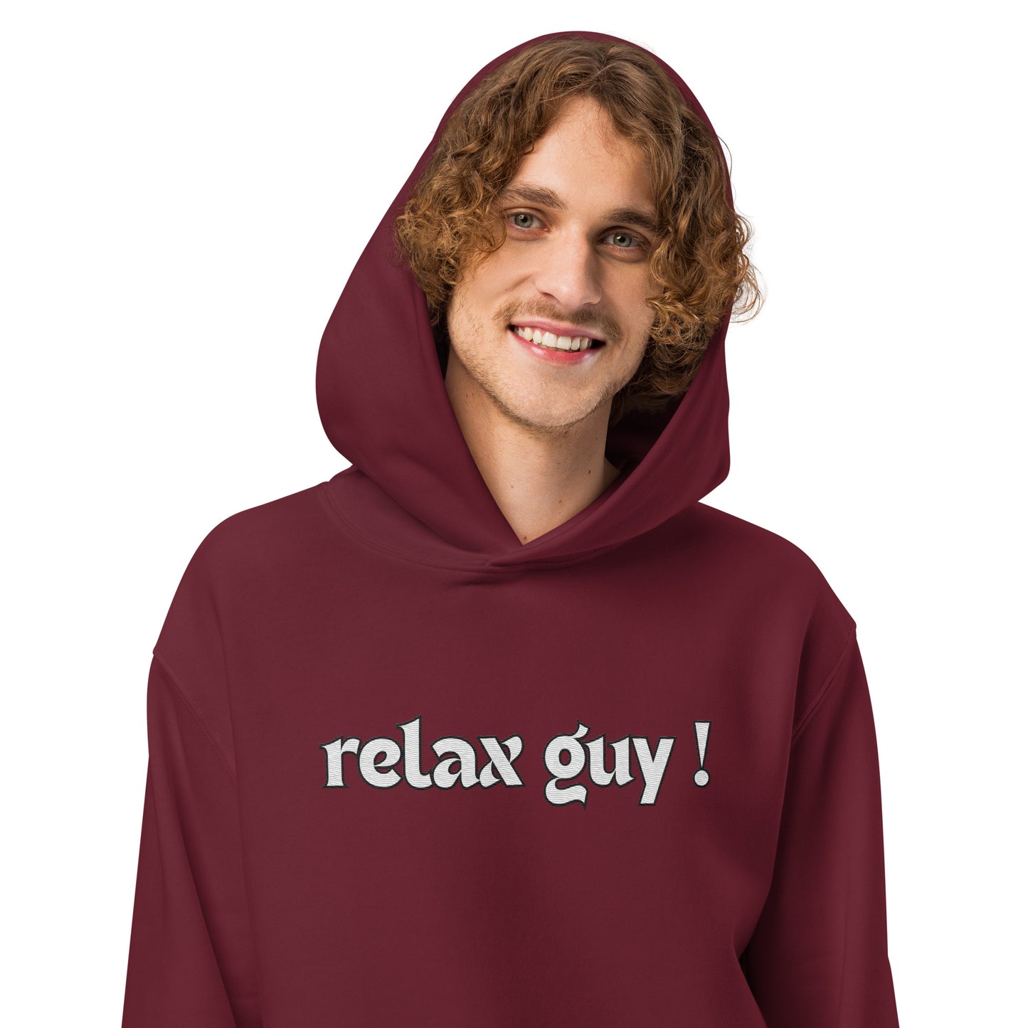 Curly-haired guy in maroon oversized "relax guy !" hoodie, smiling front pose