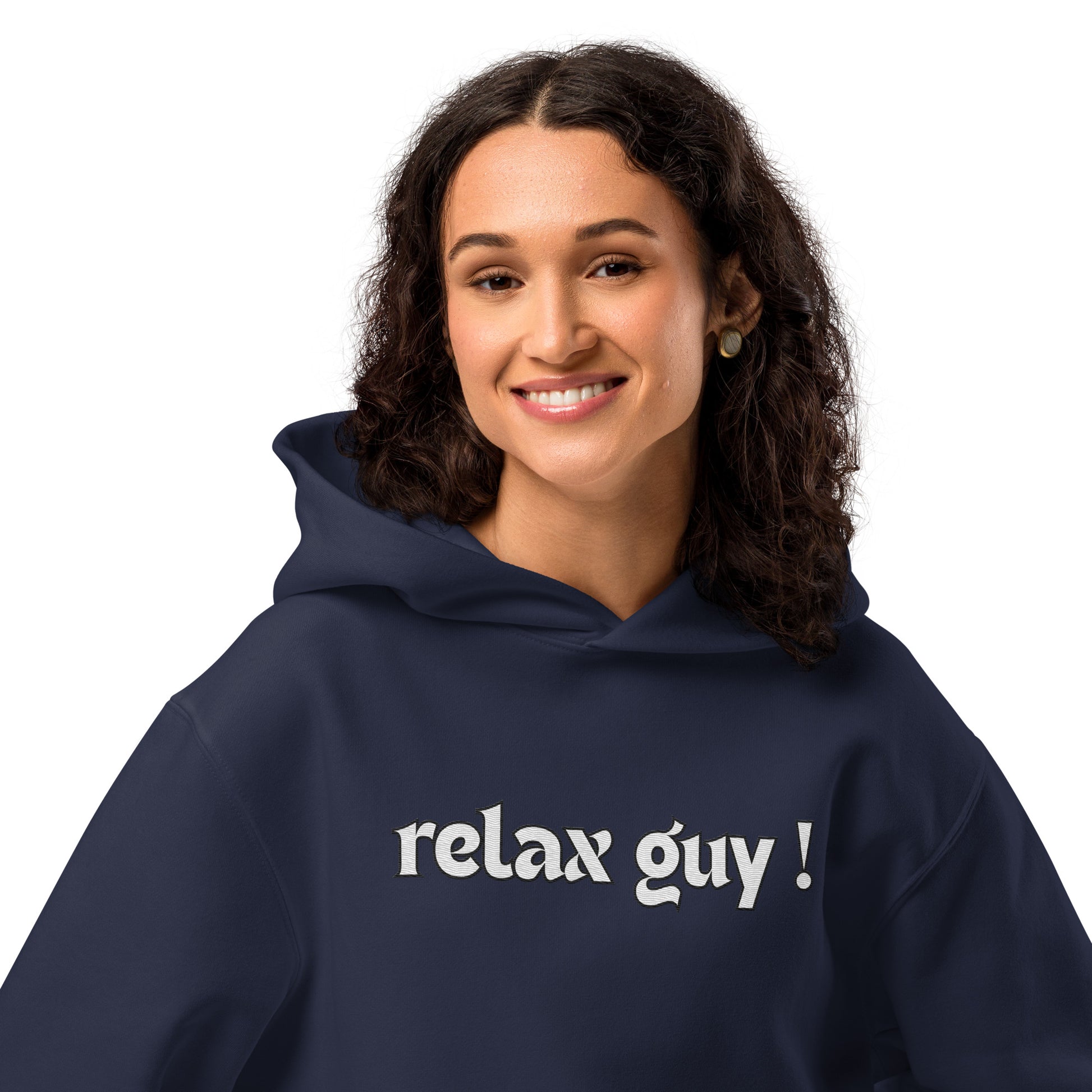 Curly-haired woman smiling in navy oversized "relax guy !" hoodie, front model shot