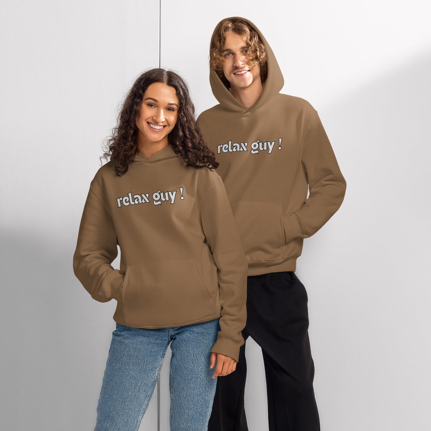 Couple chilling in matching vintage brown oversized hoodies with "relax guy!" print