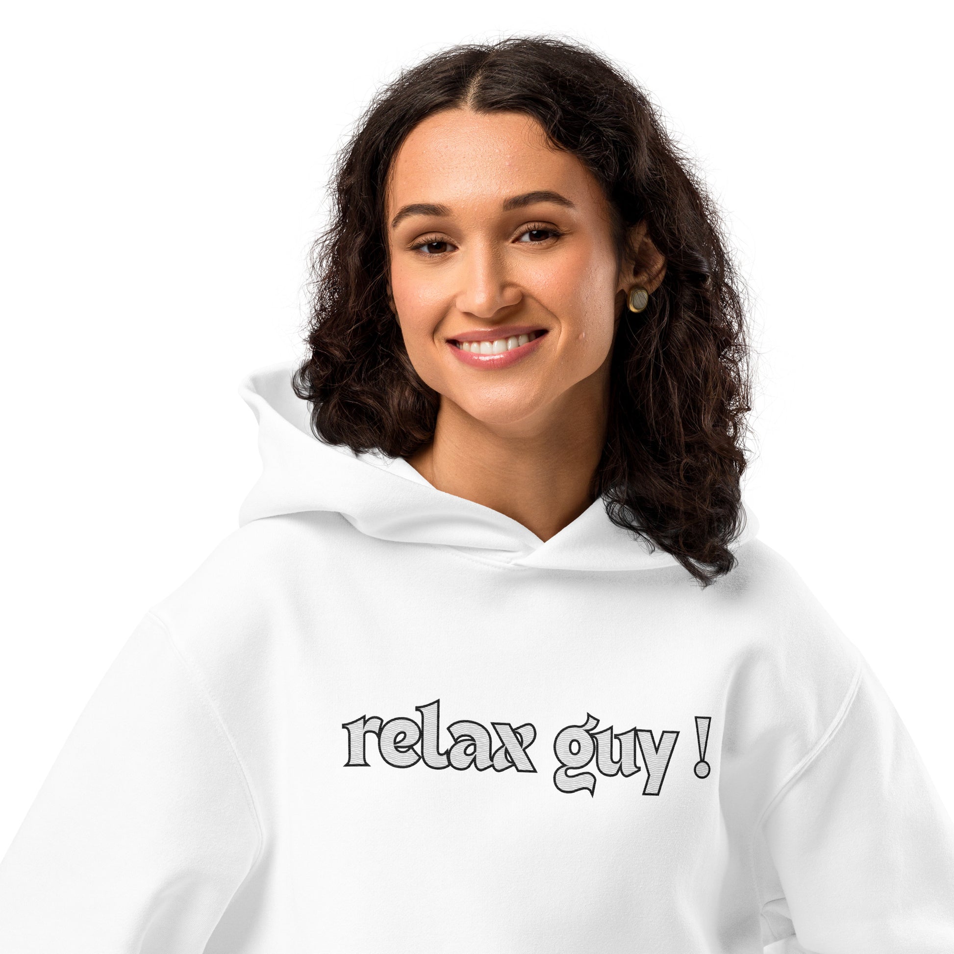 Woman smiling in white oversized hoodie with bold "Relax Guy!" chest print