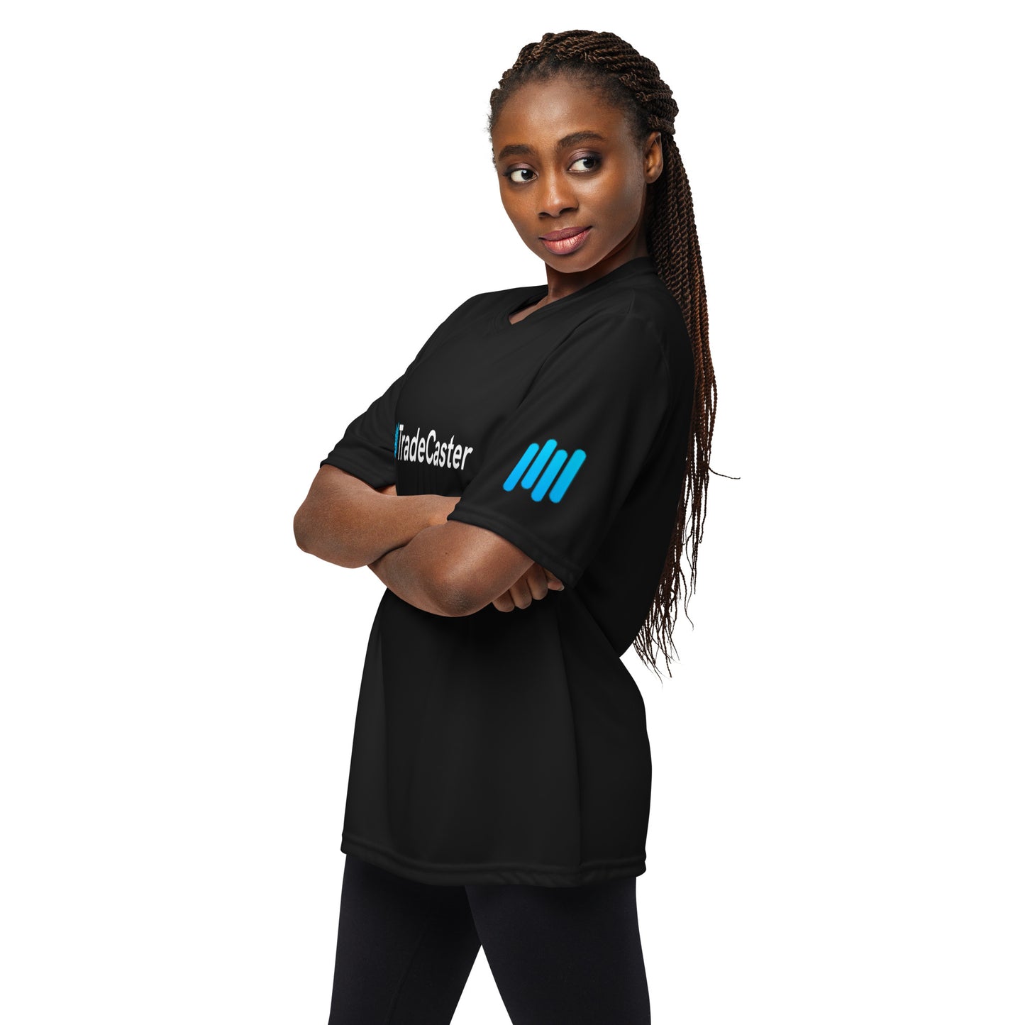 Female model arms-crossed in black TradeCaster tee, side view highlighting cyan sleeve bars
