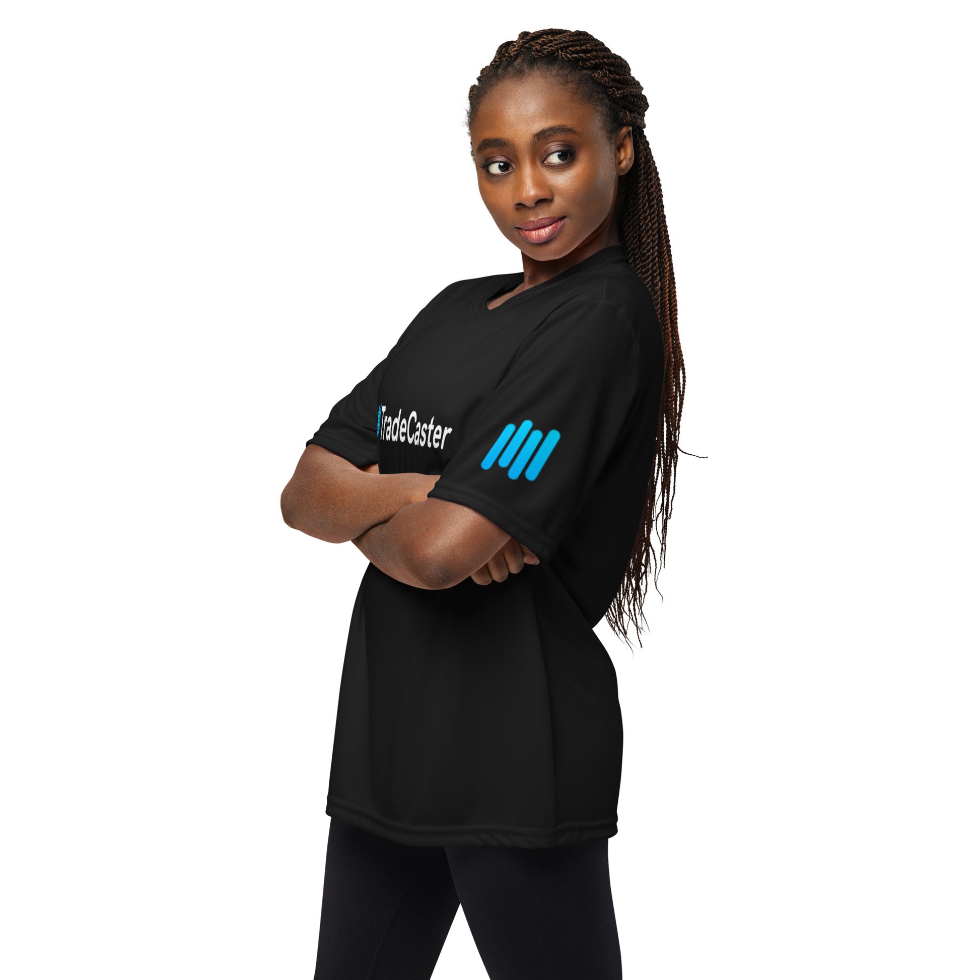 Female model arms-crossed in black TradeCaster tee, side view highlighting cyan sleeve bars
